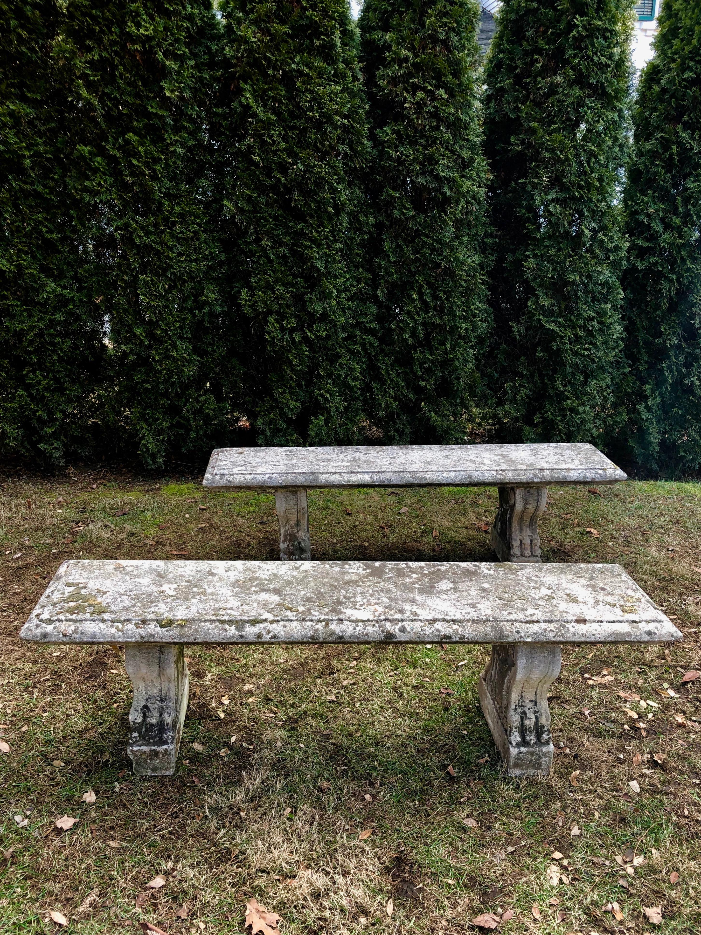 It is rare to find quality carved stone benches these days, let alone a pair, and these are beauties. With flanged edges to the tops and decoratively-carved volute and lions’ paw supports to both sides, these are exceptional in all respects. The