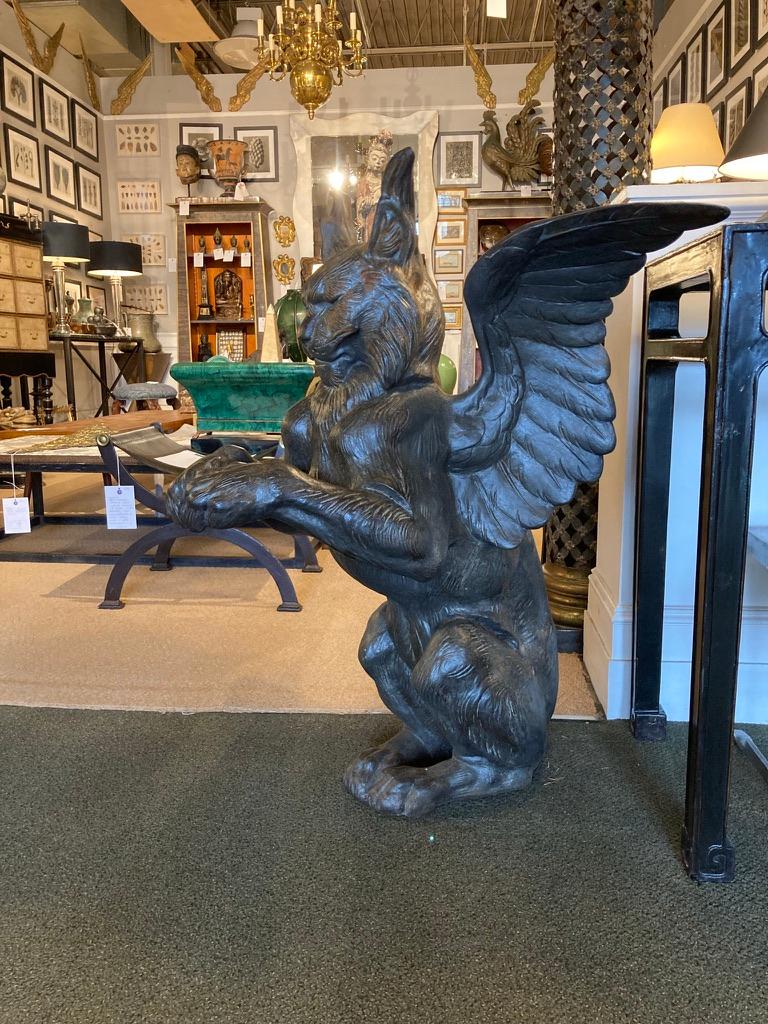 Impressive cast iron gargoyles, depicting winged cats, seated on their haunches with paws raised. Originally the paws must have rested on a railing or a rampart, there is a bolt hole where they were once attached. Quite substantial, they stand on