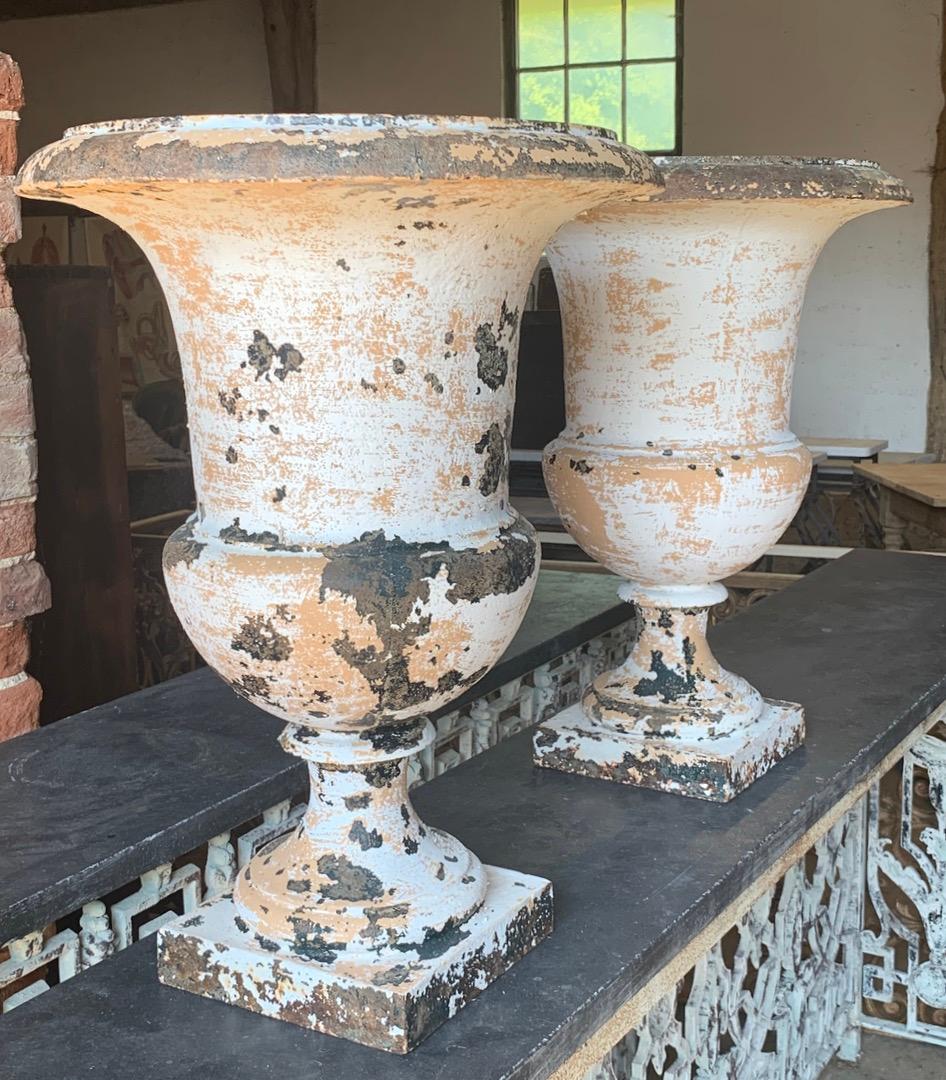 A lovely pair of early 19th century French cast iron urns with nice old weathered paint. These will look good indoors as well as in the garden.