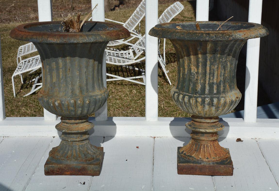 Pair of classic form antique French cast iron garden urns, planters or jardinières. Wonderful aged patina. A great addition to any garden or room.