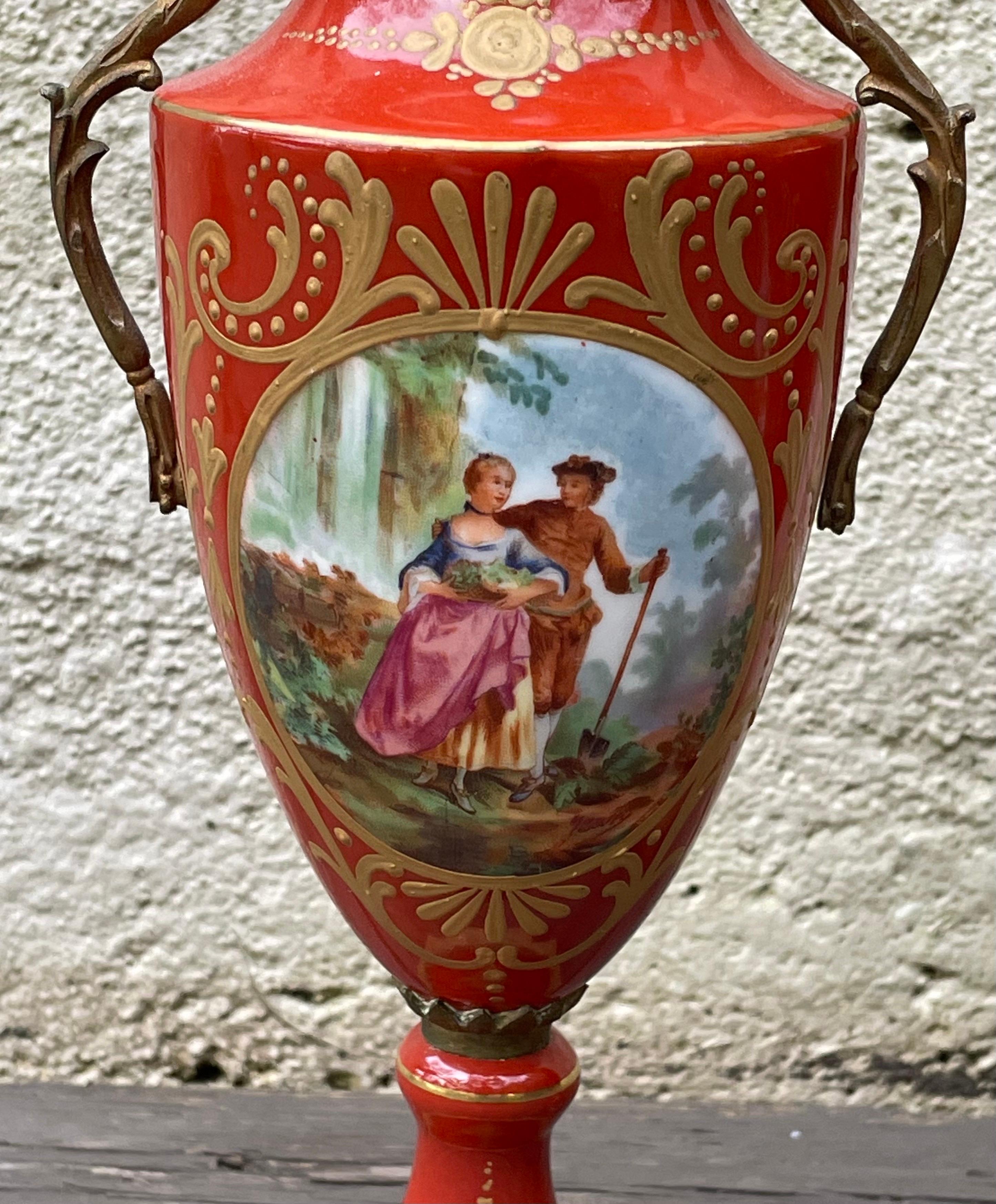 Beautiful pair of 19th century hand painted ceramic urns with cast bronze base and handles, France.