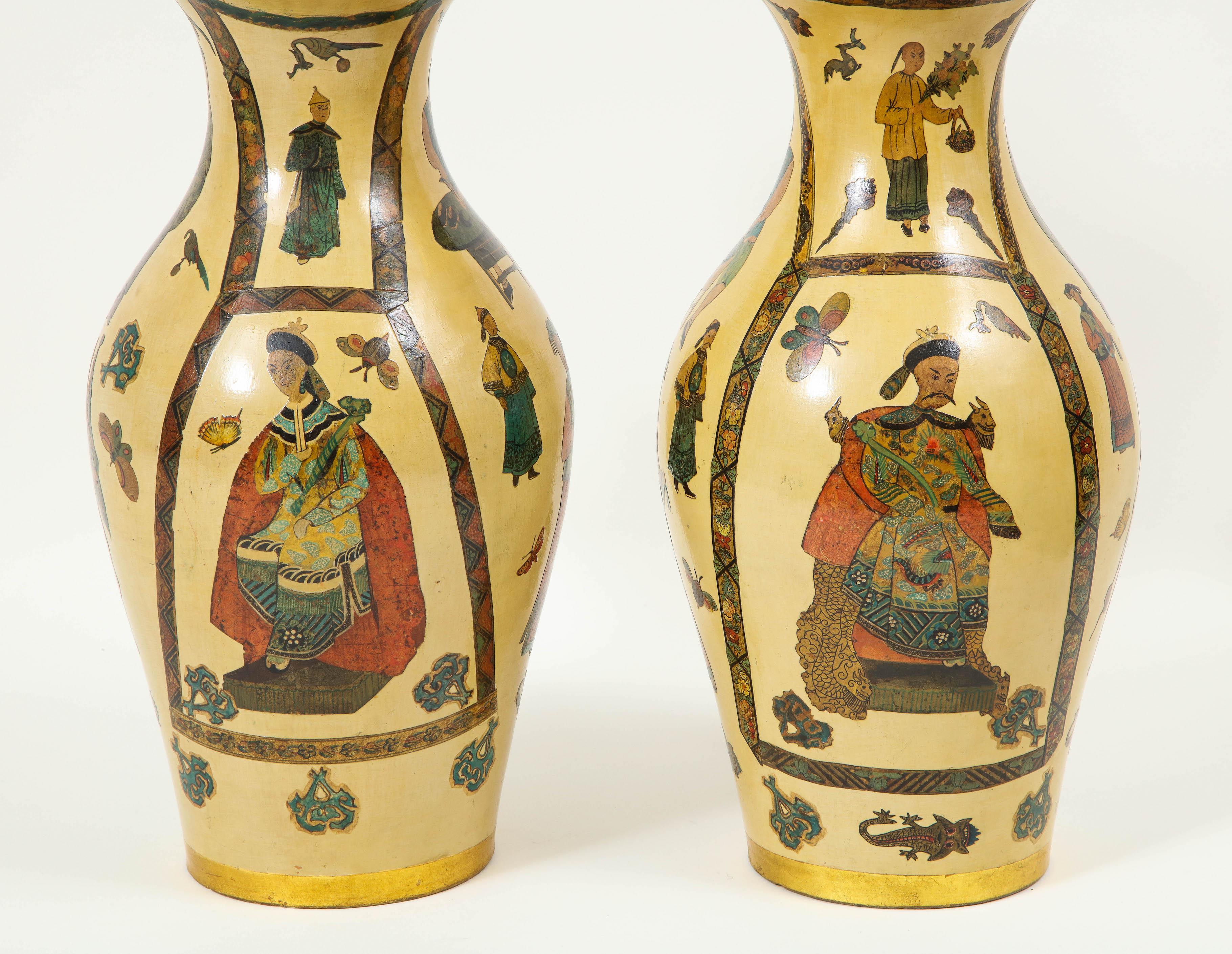 Each wooden lamp pained an ochre yellow and decoupaged with chinoiserie figures and emblems set within borders. Electrified at a later date. Height to top of lamp is 16.25