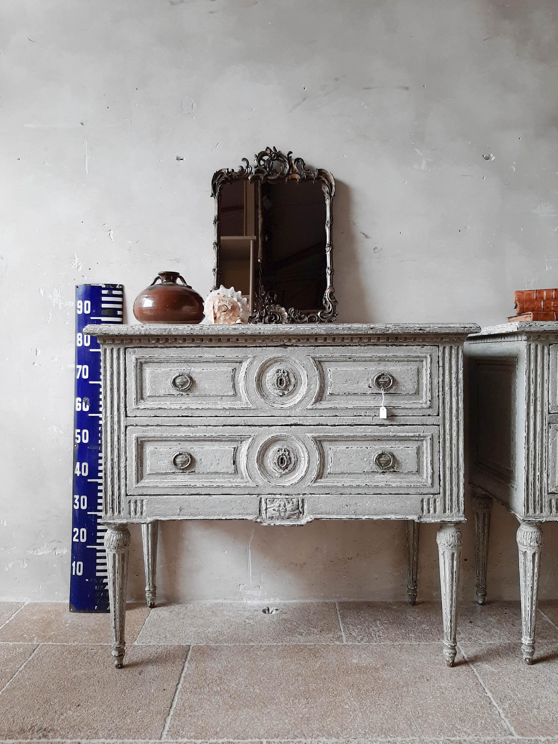 Pair of antique commodes from 19th century France. These beautiful chest of drawers have an oakwood exterior that has been patinated in an aged grey and with the stunning details on the drawers and legs, this Louis XVI style commode will certainly