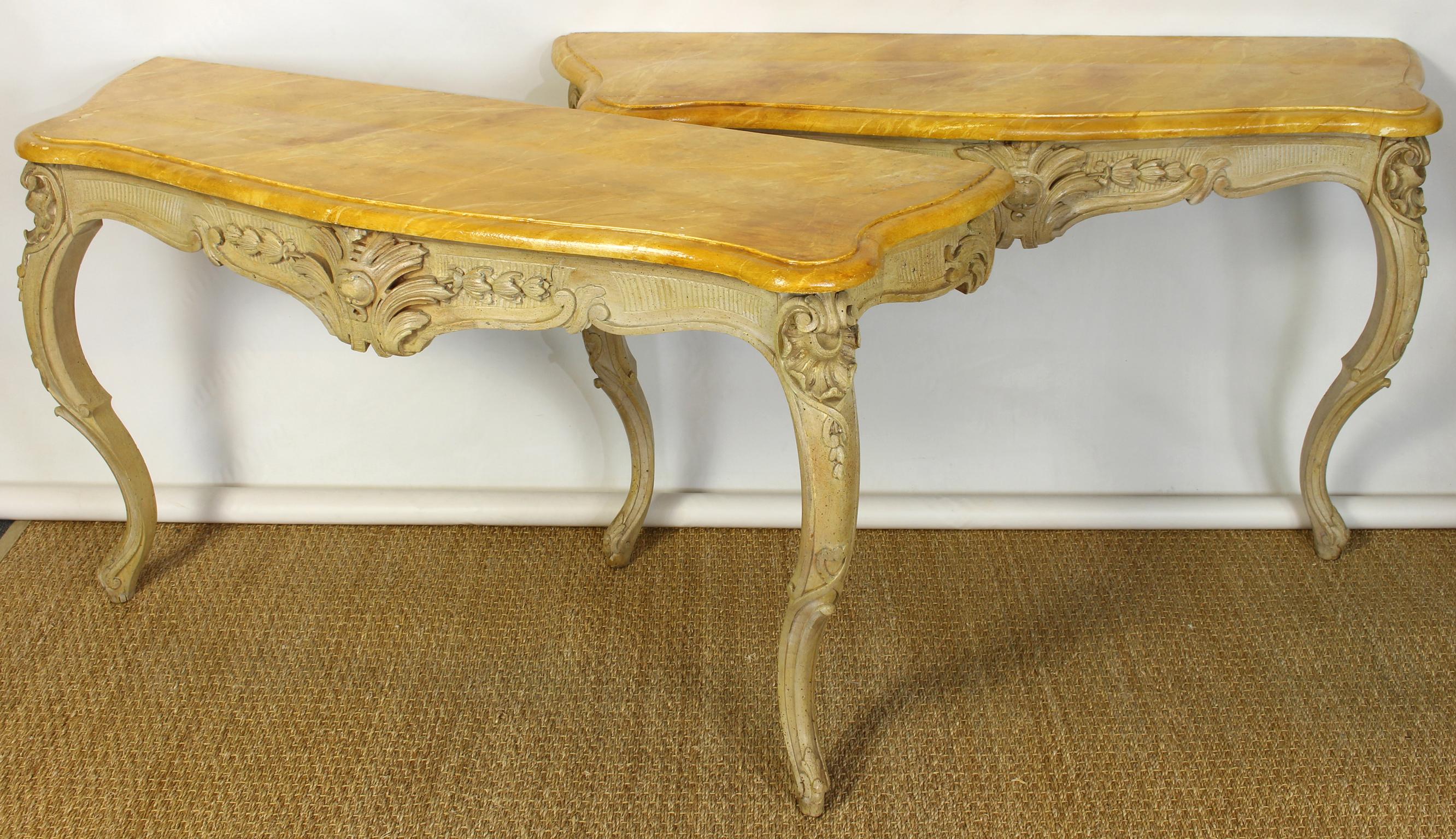 A lovely pair of carved and painted mid-19th century French wall mounted console tables with faux marble tops.