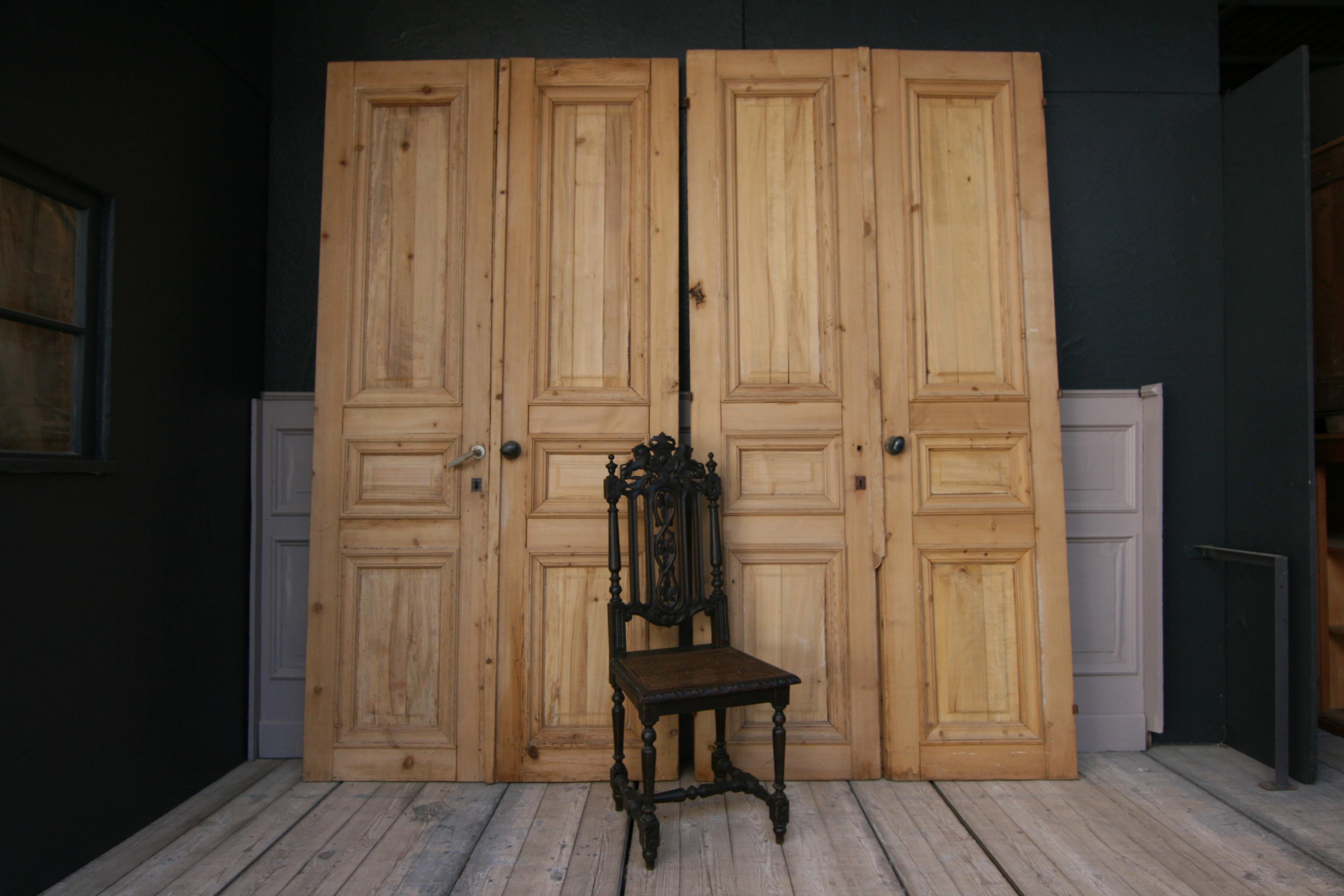 Two 19th century French double doors (= total of 4 single doors in a set), formerly from a hotel in Paris. Solidly made of pine wood and freed from old paint (bleached wood).

Dimensions: 
250 cm high / 98.42 inch high,
64 cm (single door) or