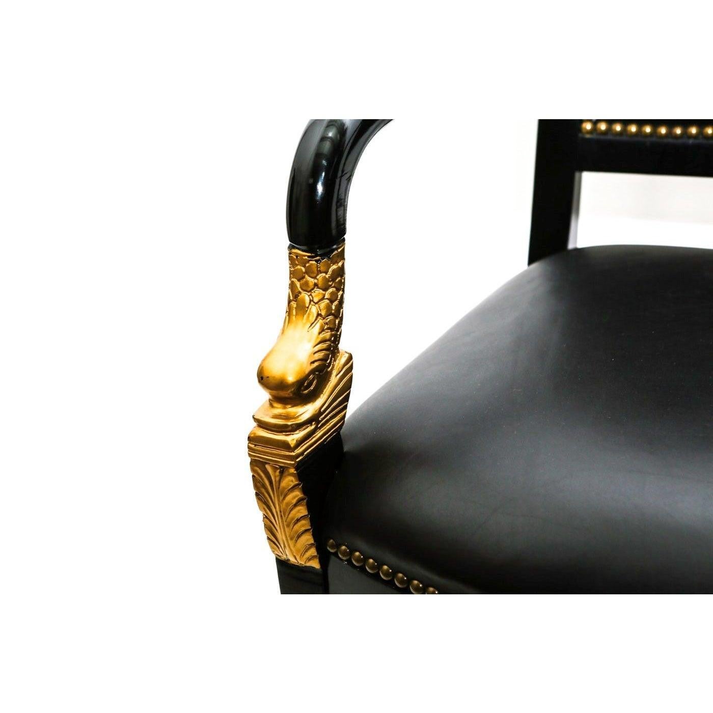 Late 19th century pair of majestic French Empire mahogany fauteuils (open armchairs) finished in a rich black lacquered color. This pair of chairs consist of a top rail leading down to shaped arms with carved foliate design and superbly carved