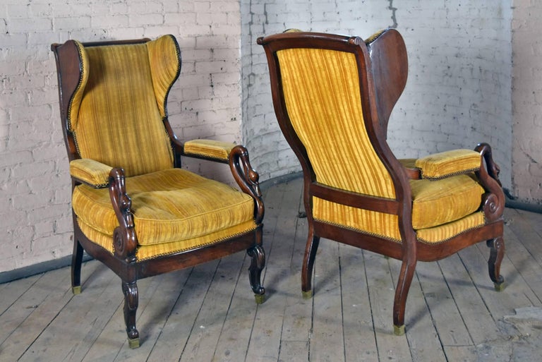 Exceptional Pair of late Empire Period Chairs, of Comfortable Size and Flowing Movement of Form. The accentuated wings beautifully complementing the wavy movement of the back and back legs, the arms ending in scrolling swan’s necks, the front legs