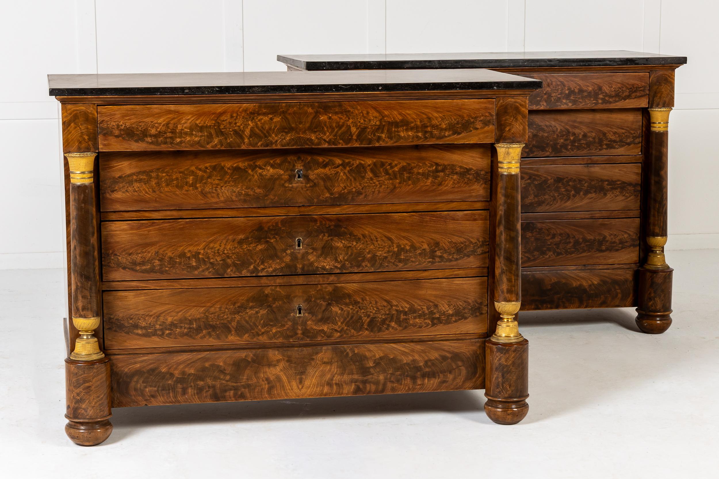 A Very Fine Pair of French Empire Period Mahogany Commodes with Marble Tops.

Made in the early 19th century, this pair of mahogany commodes are veneered in bookmatched timber of the finest quality. The curly veneers on the drawer fronts read