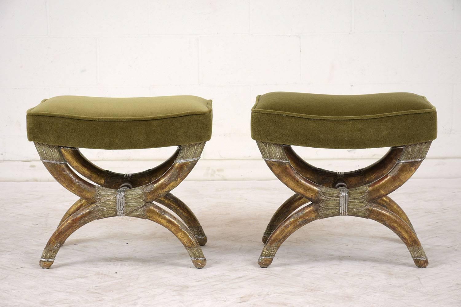 This pair of 1820's French Empire-style benches feature the original 24 karat giltwood x-shaped legs with carved leafy details throughout. The benches have been completely restored with new upholstery and cushions. The seats are upholstered in a