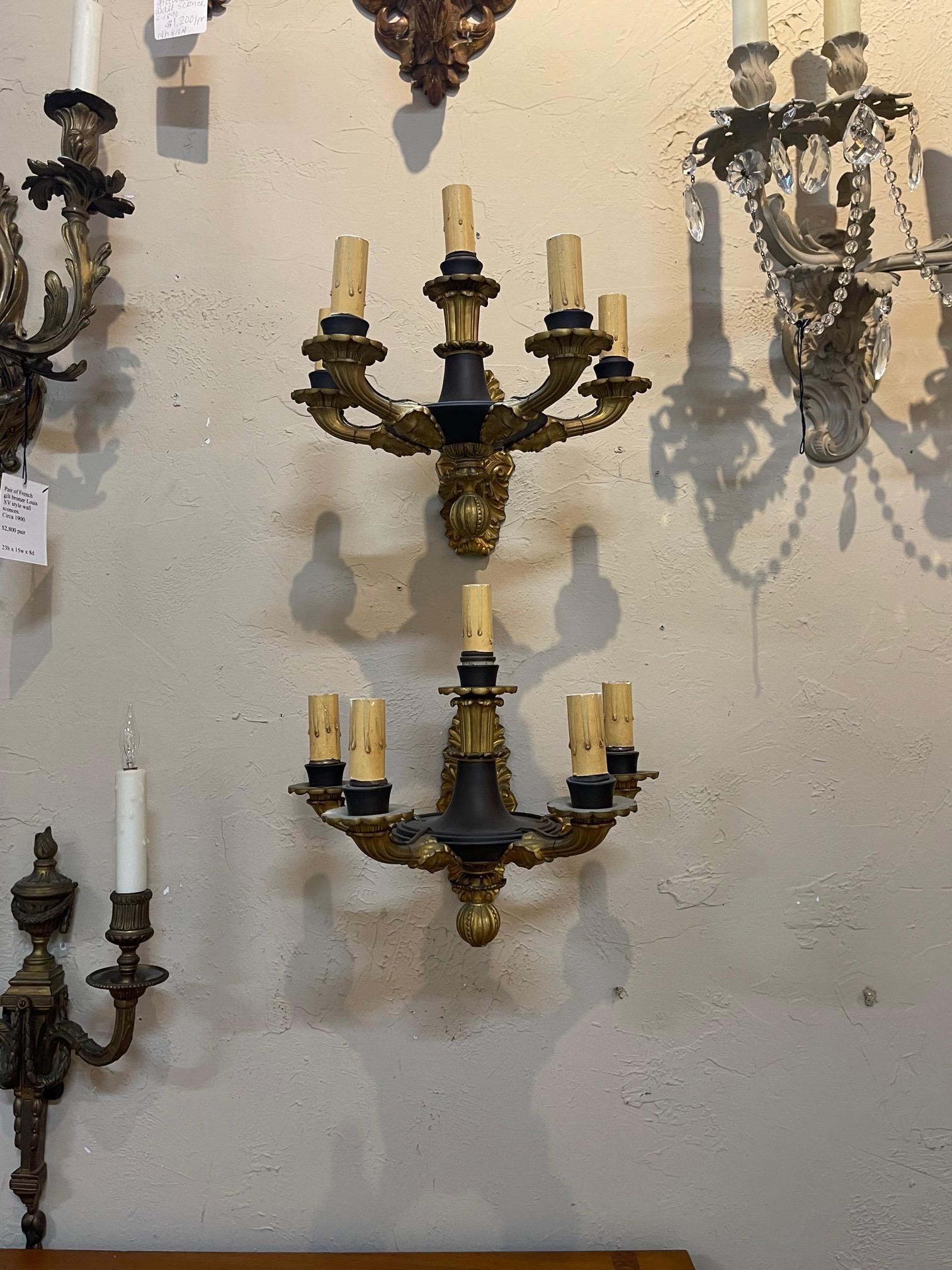 French Empire style pair of gilt bronze sconces with 5 lights. A classic pair in the colors of gold and black. Very nice!.
