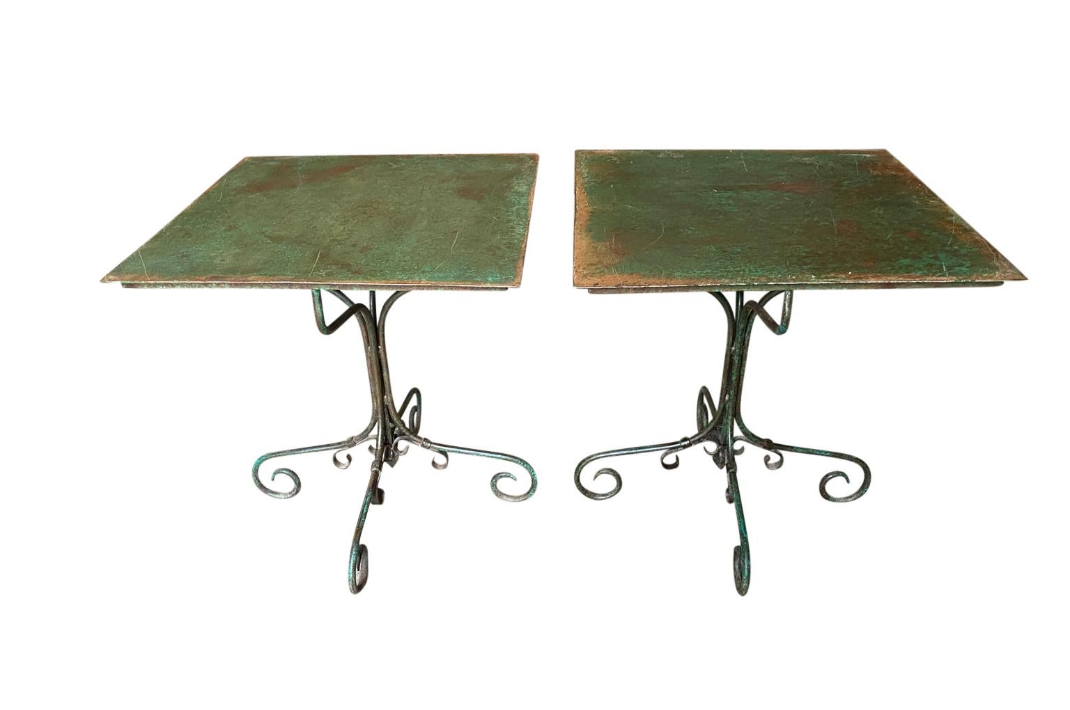 A delightful pair of 19th century Garden tables from the Provence area of France. Soundly constructed from painted iron. These tables will add charm to any casual interior of garden.