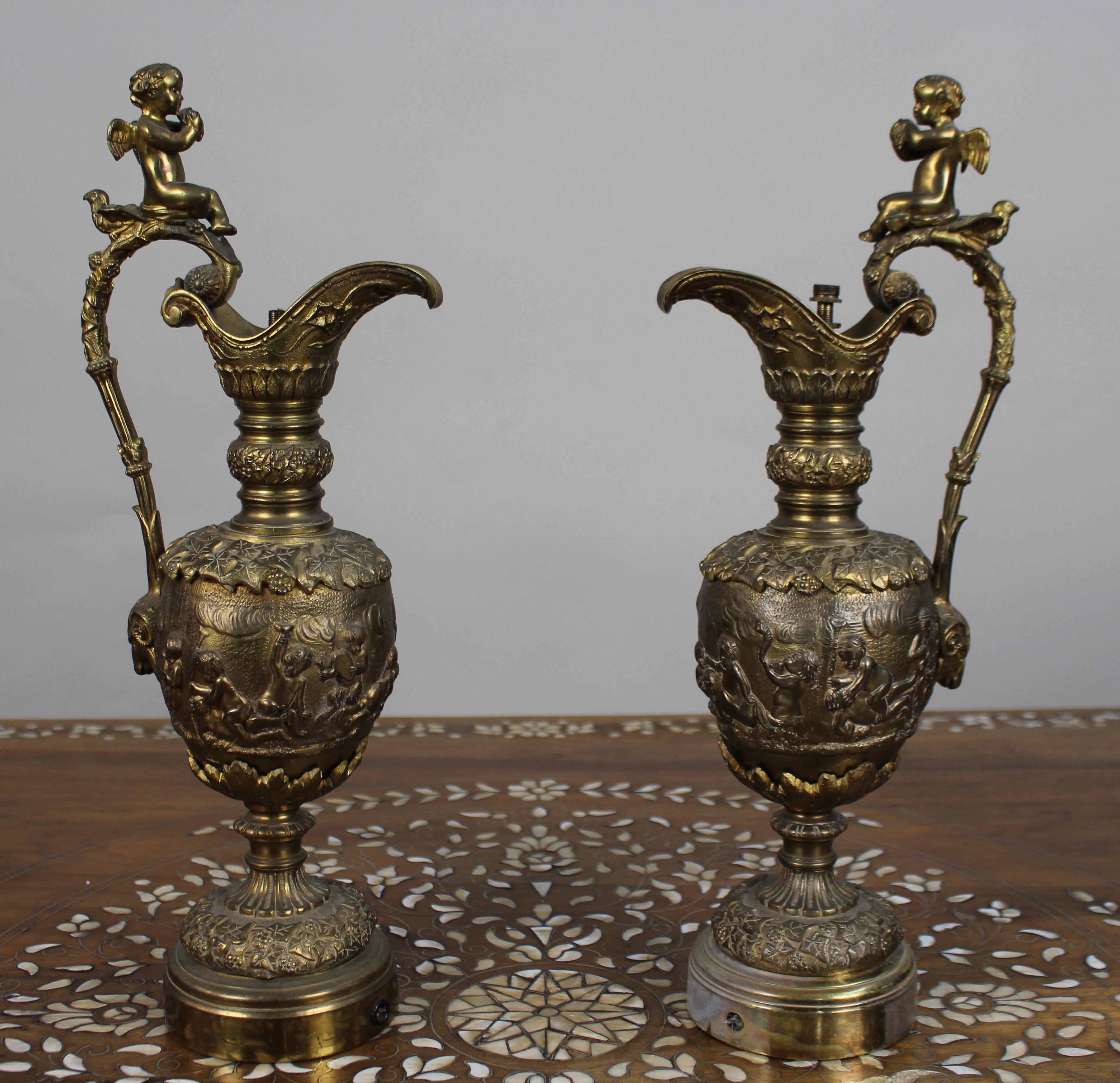Pair of 19th Century French Gilt Bronze Bacchanalian Ewers with Cherubs


A fine and decorative pair of French gilt bronze ewers in the Renaissance Revival taste, richly cast with Bacchanalian scenes of playful putti amid vines and grapes. Each ewer