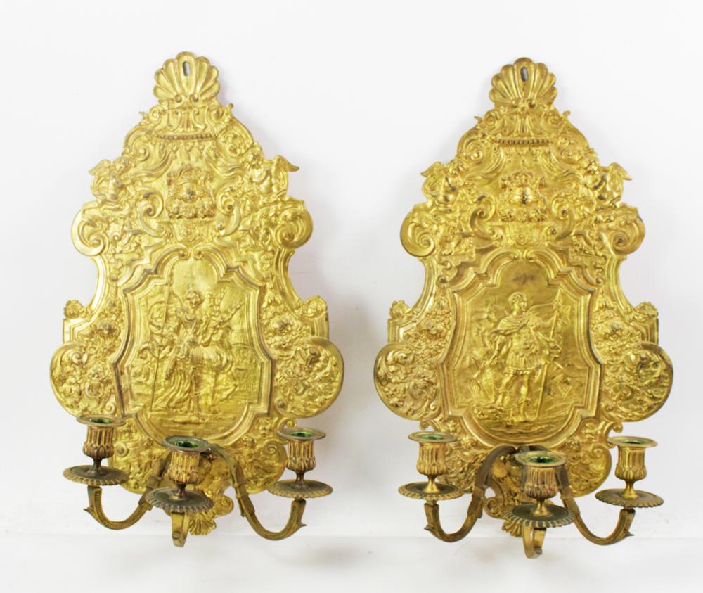 Pair of 19th Century French Cast Bronze Sconces depicting Diana The Huntress. Each with a shell motif at the top, with a highly decorative scrolled shield back. Each holds three candles, and they are not electrified. The arms, candle holders, and