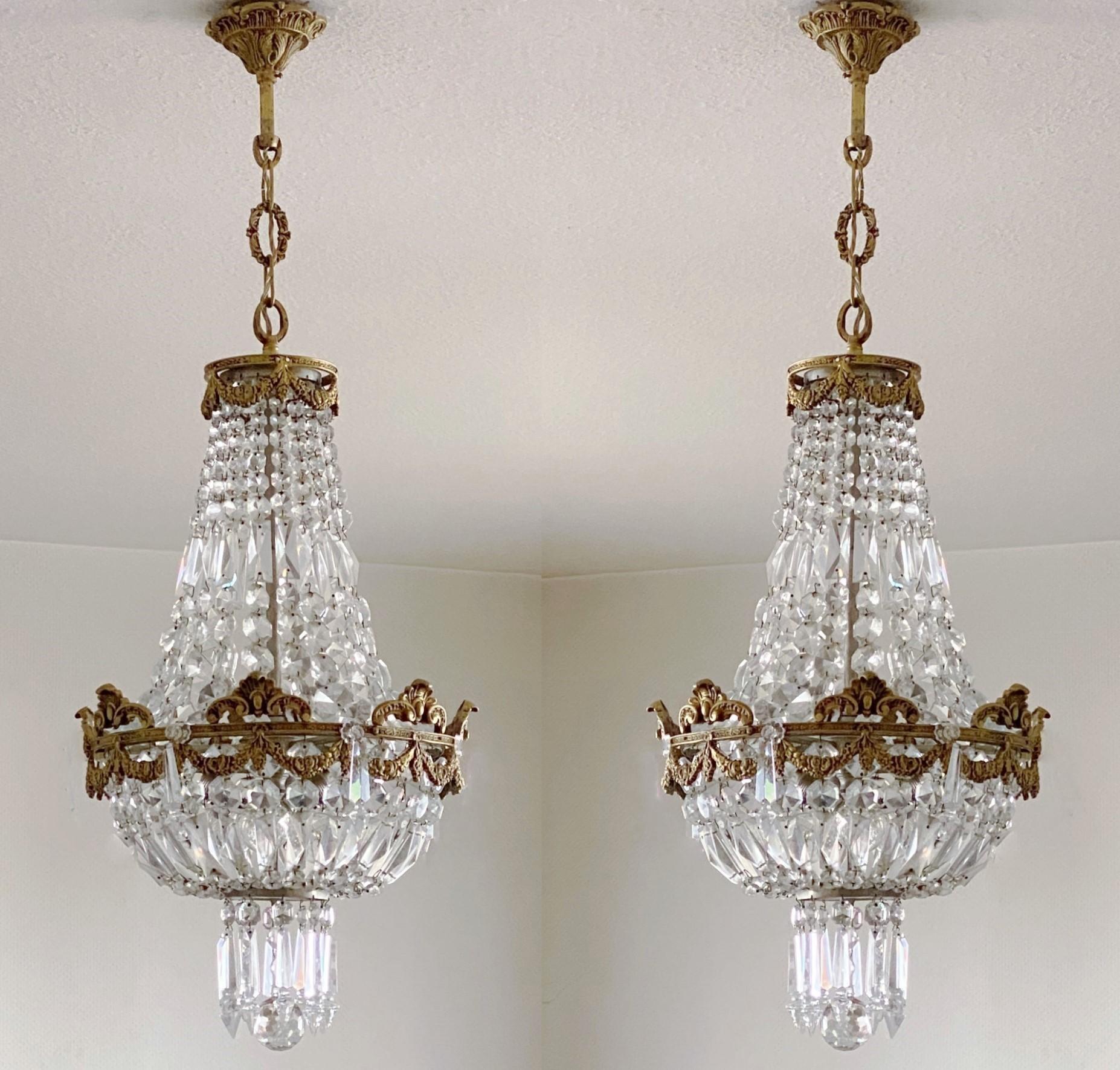 A beautiful pair of Louis XV style faceted crystal and solid gilt bronze basket form chandeliers or lanterns, France 1880-1890. Richly decotate with swags and crystal hangings. In fine antique condition, wonderful aged patina to bronze, professional