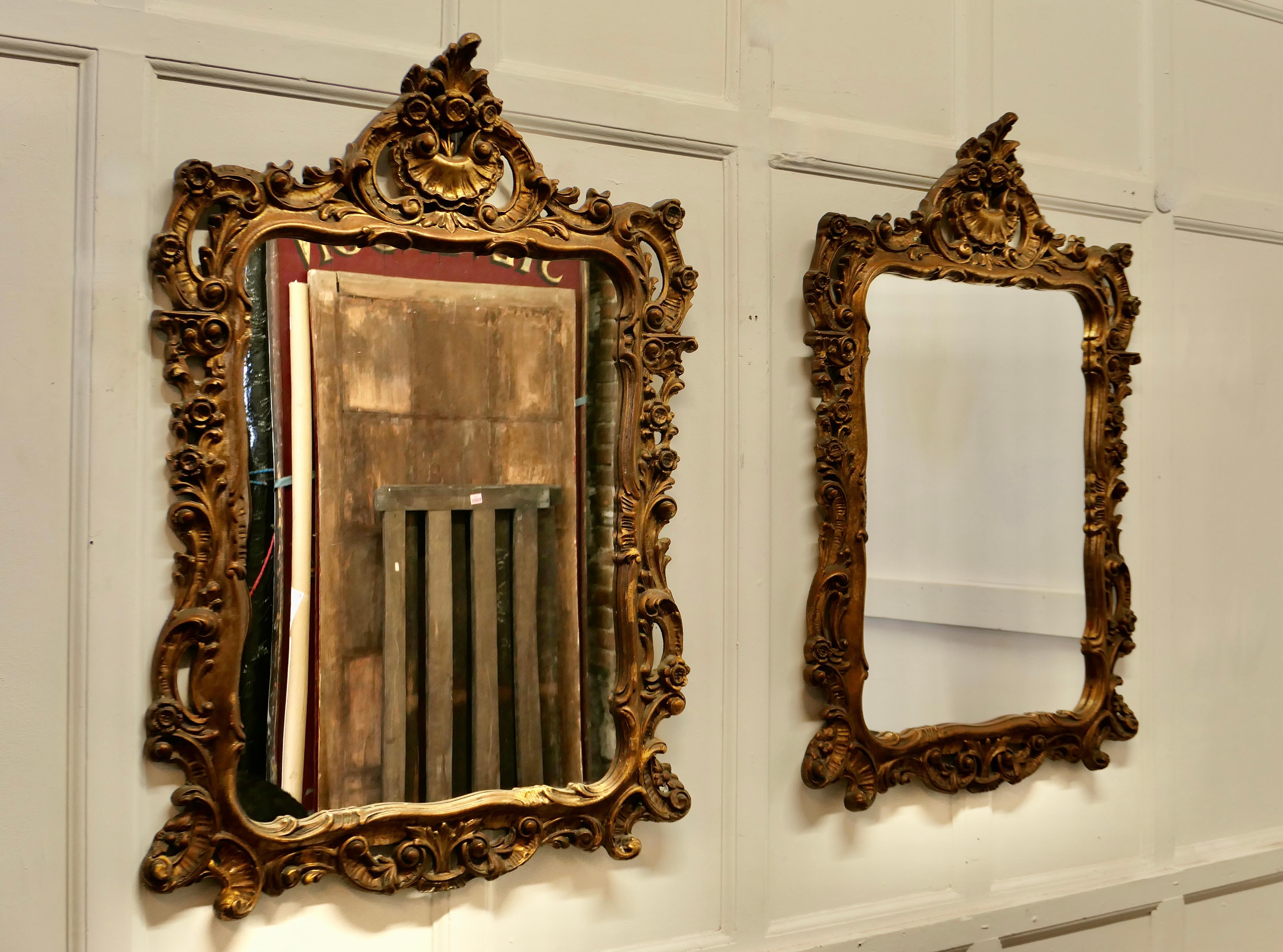 Pair of 19th Century French Gilt mirrors

These are a beautiful Pair of old Gold Framed Mirrors, the mirrors have a tall pediment with shell decoration at the top and gilded carving, around the rest of the 4” wide frame 
The mirrors are in good