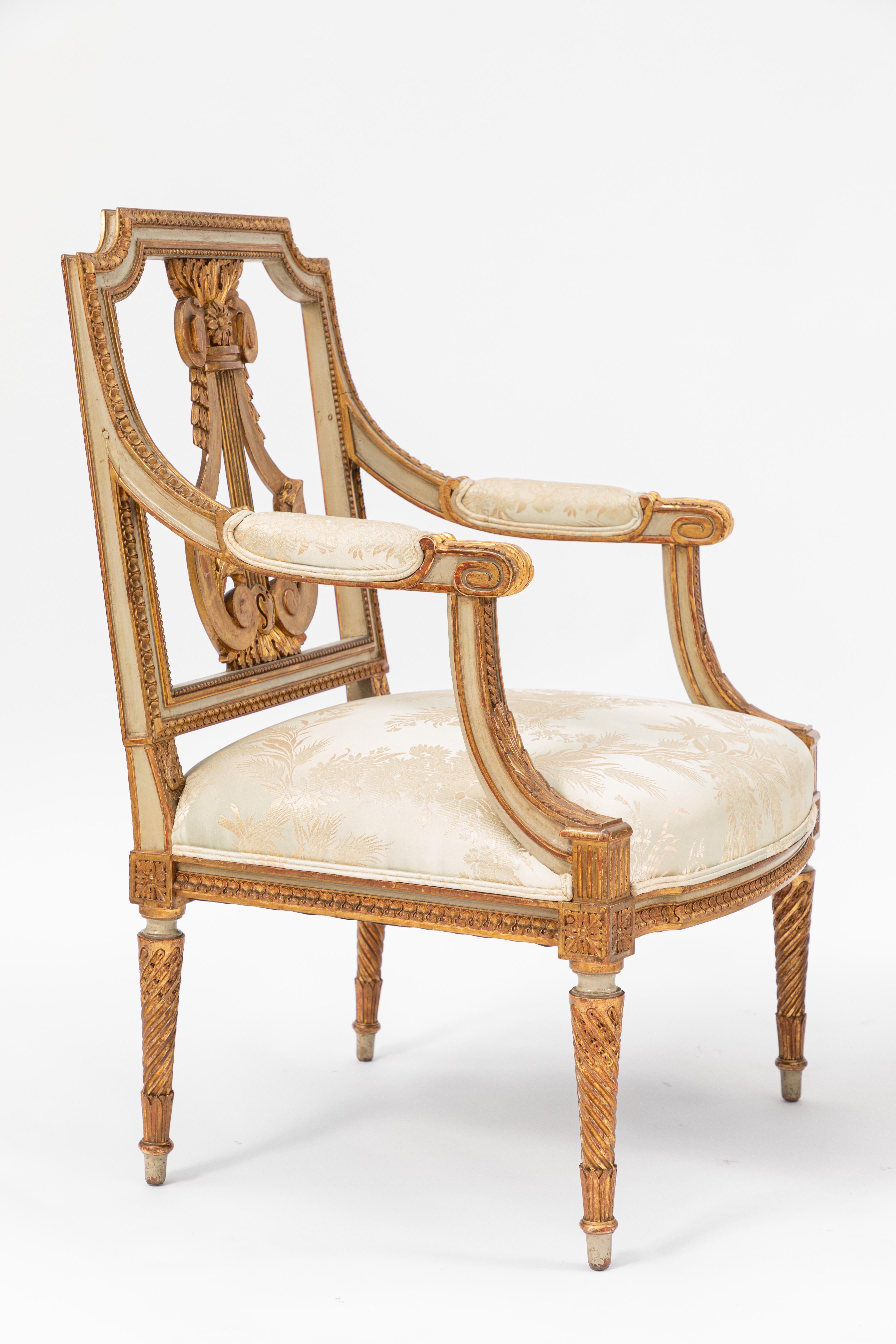 Rare pair of fine early 19th century French painted giltwood armchairs with lyre motif.