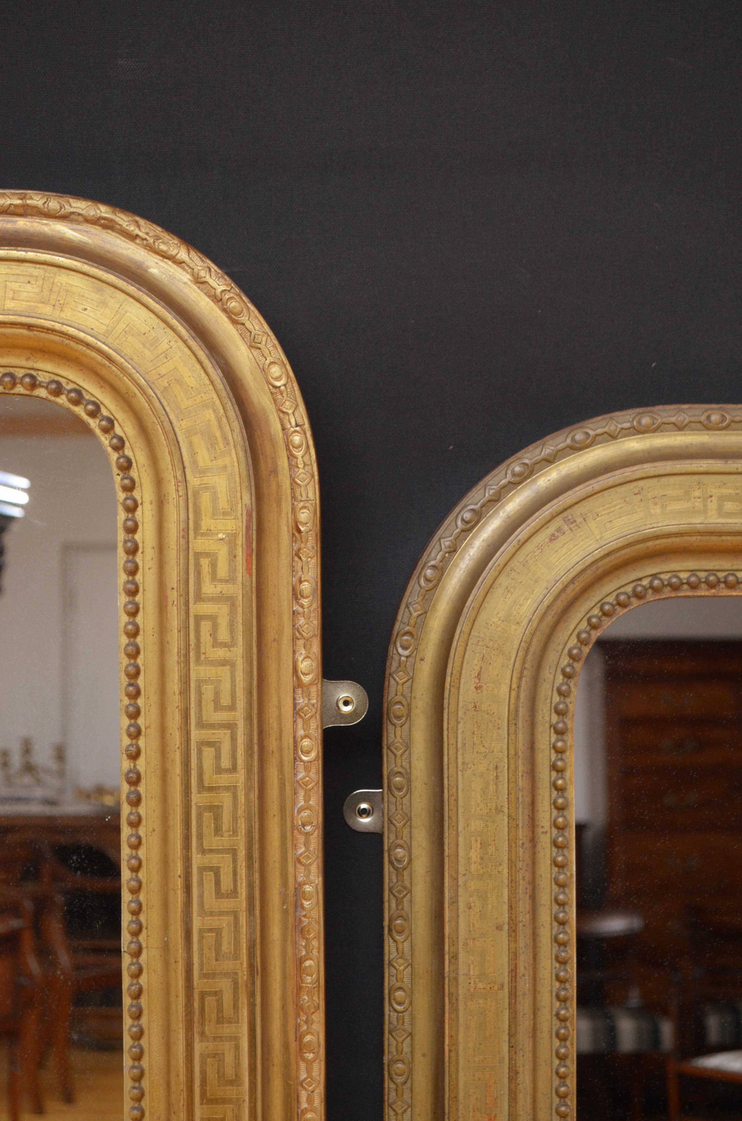 Sn4802 pair of French gilded wall mirrors, each having original glass with some foxing in beaded, Greek key decorated and carved giltwood frame. This pair of mirrors retains original glass, gilt and backboards all in fantastic home ready condition,