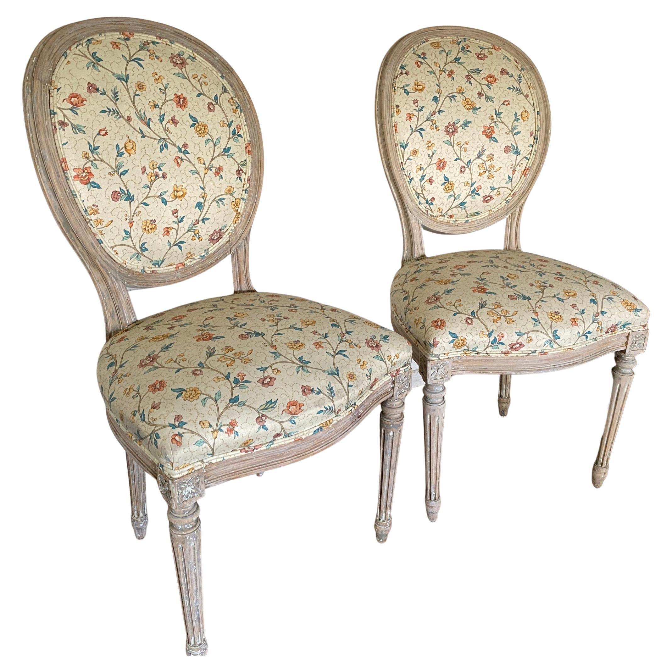 Pair of French Louis XVI style, aged patinated painted side chairs with oval backs and fluted legs. The distress paint gives the chairs added character and style. Use for dining or in the bedroom, French, Swedish Gustavian, country or classic modern