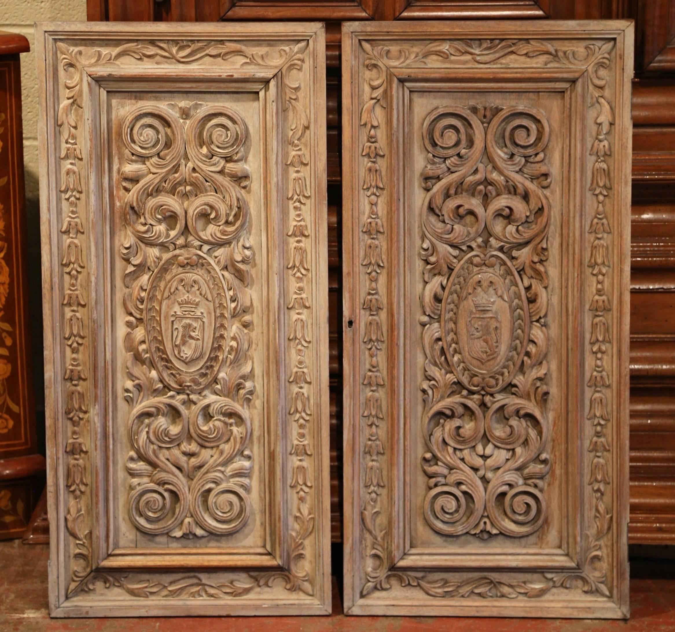 Patinated Pair of 19th Century French Hand-Carved Walnut Panel Doors with Family Crests