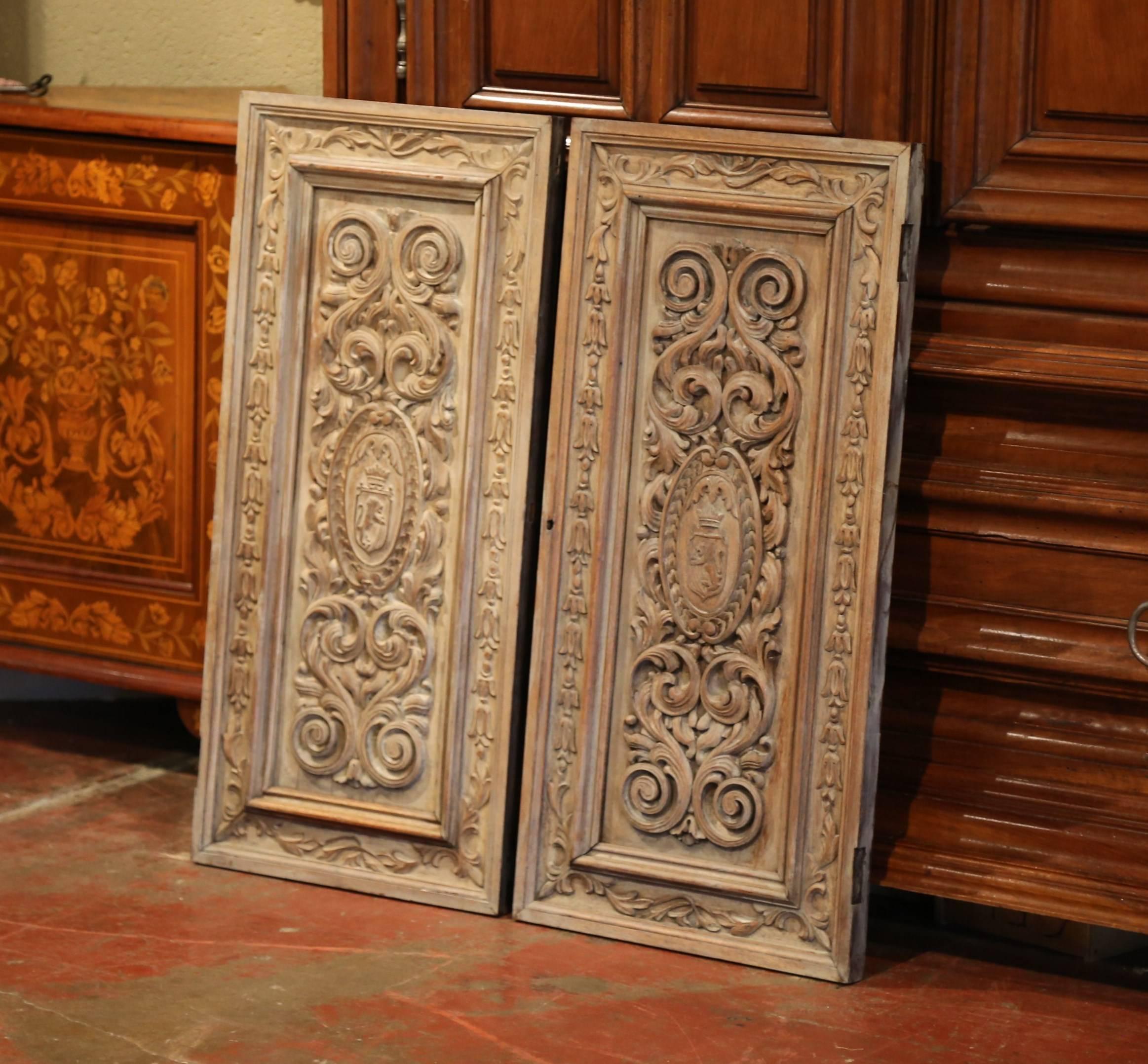 Pair of 19th Century French Hand-Carved Walnut Panel Doors with Family Crests In Excellent Condition In Dallas, TX