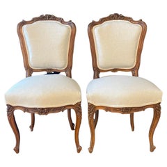 Pair of 19th Century French Intricately Carved Walnut Louis XV Chairs 