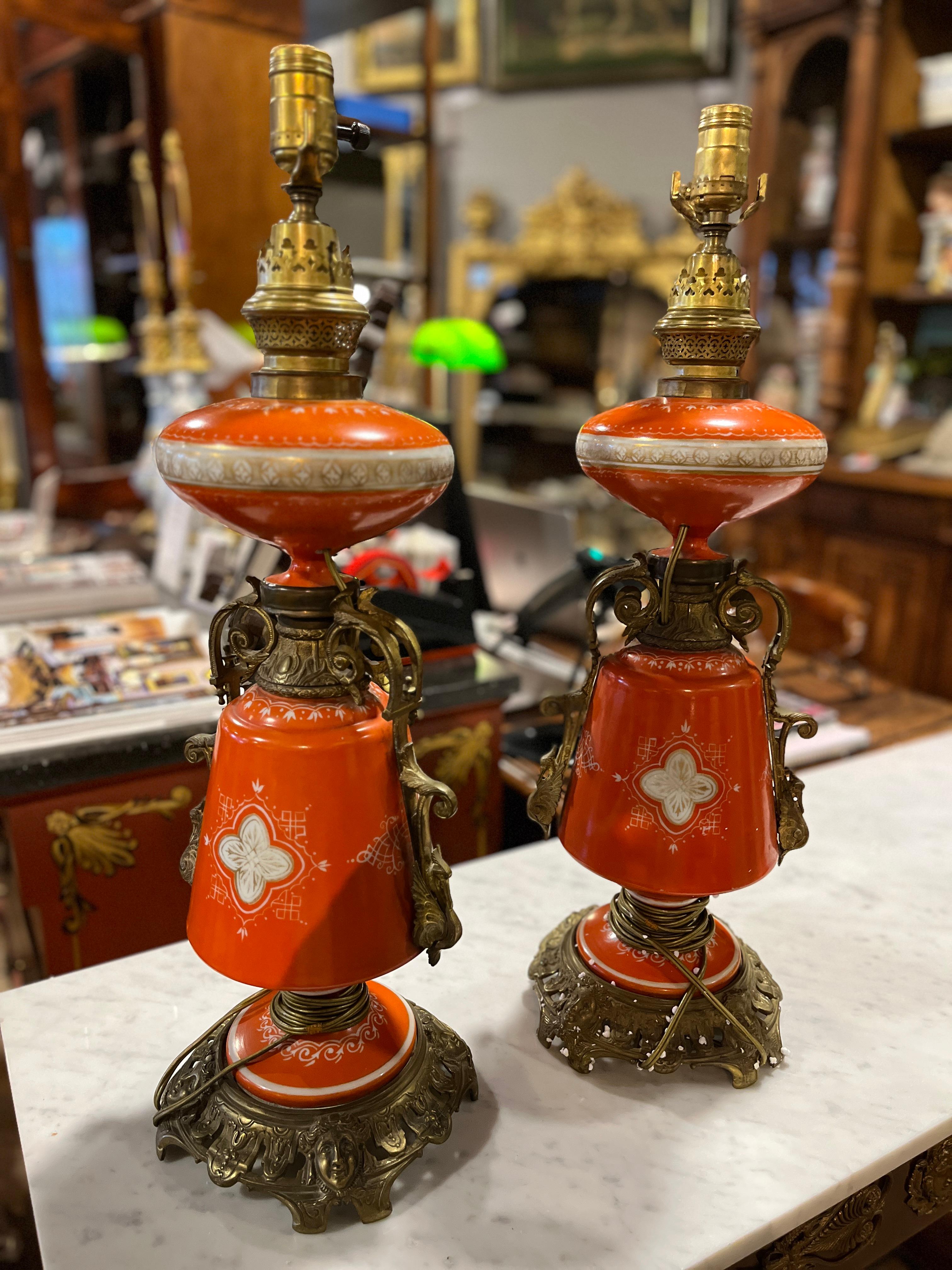 Pair of 19th Century French Lamps with Neoclassical scene. Appropriate age and wear and just a beautiful shade of persimmon orange.