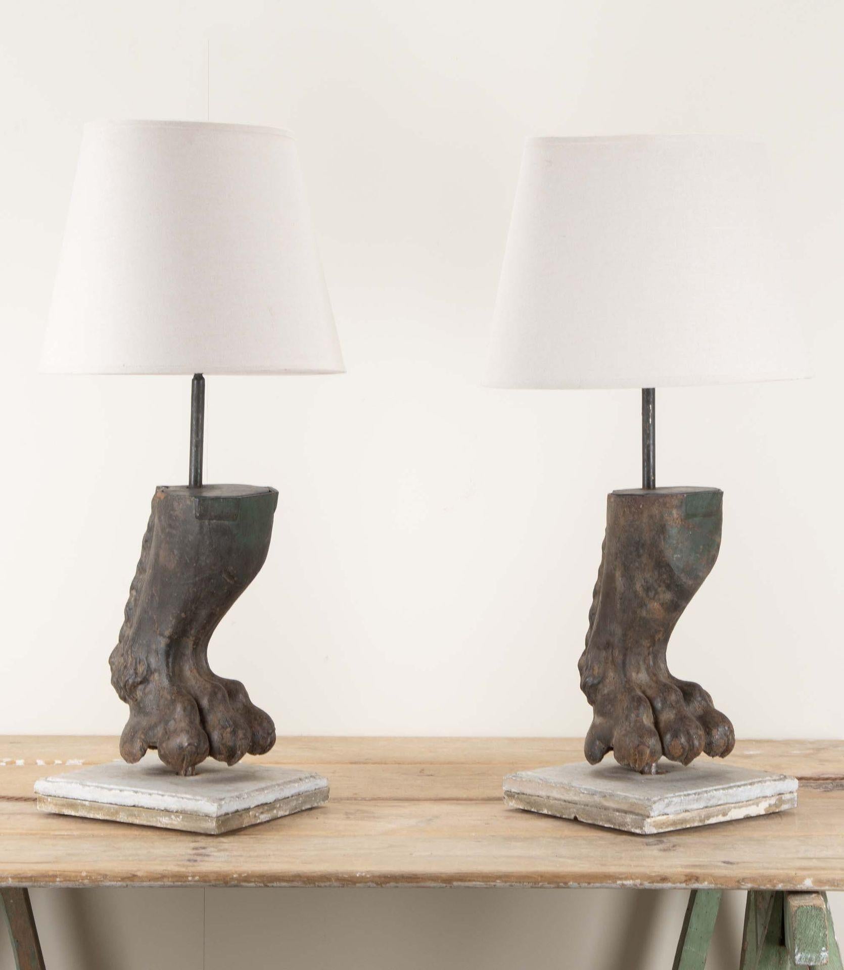 A fantastic pair of 19th Century cast iron lion paw lamps. 
Repurposed from architectural elements. With lampshades included.
Circa 1890.