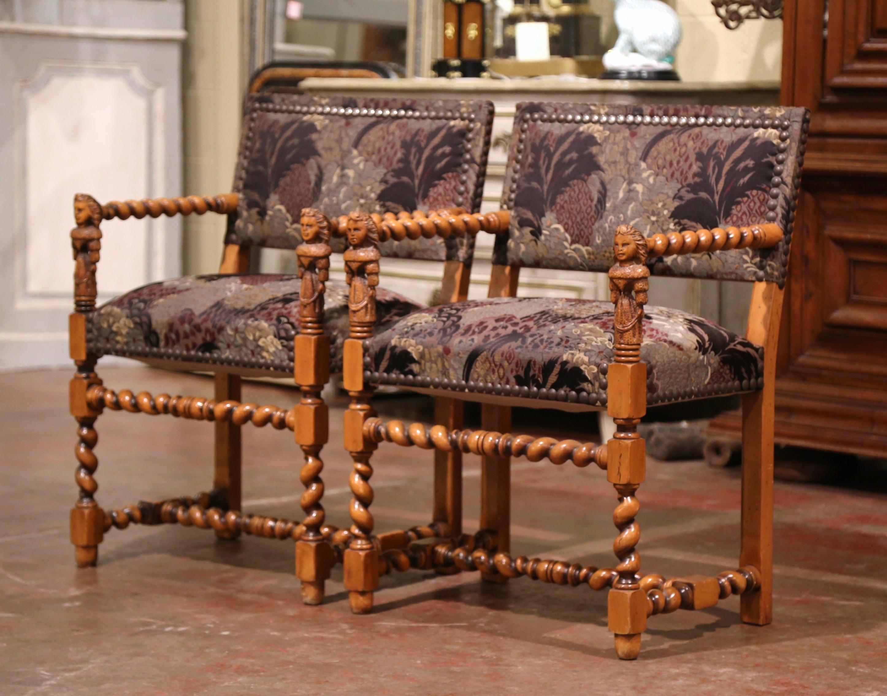 These elegant antique fruitwood armchairs were created in the Périgord region of France, circa 1880. Each chair stands on carved barley twist legs with double stretcher; the armrests are decorated with charming, hand carved female figures. The