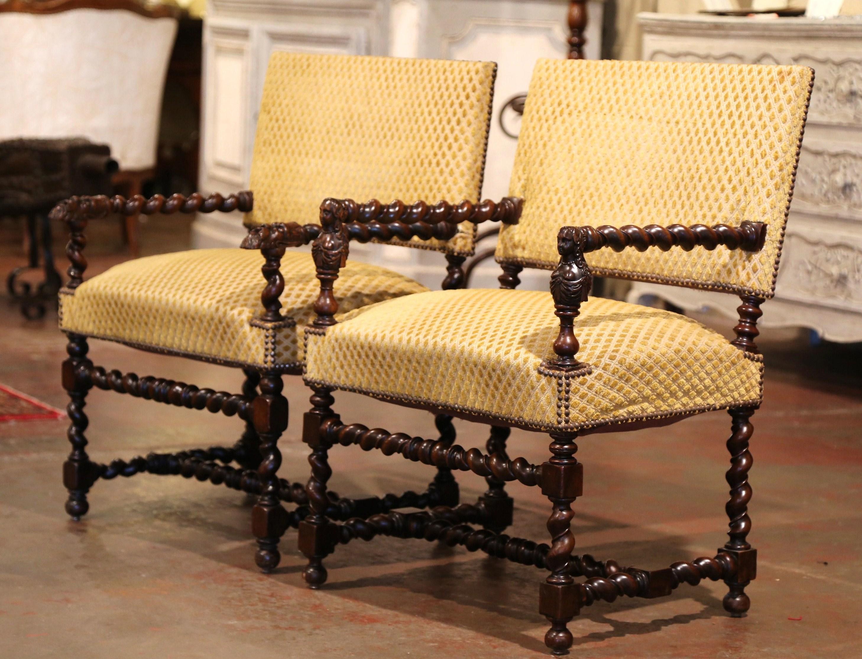 These elegant antique fruitwood armchairs were created in the Perigord region of France, circa 1870. Each chair has a rectangular back, carved barley twist legs with matching stretcher and armrests decorated with charming, hand carved female