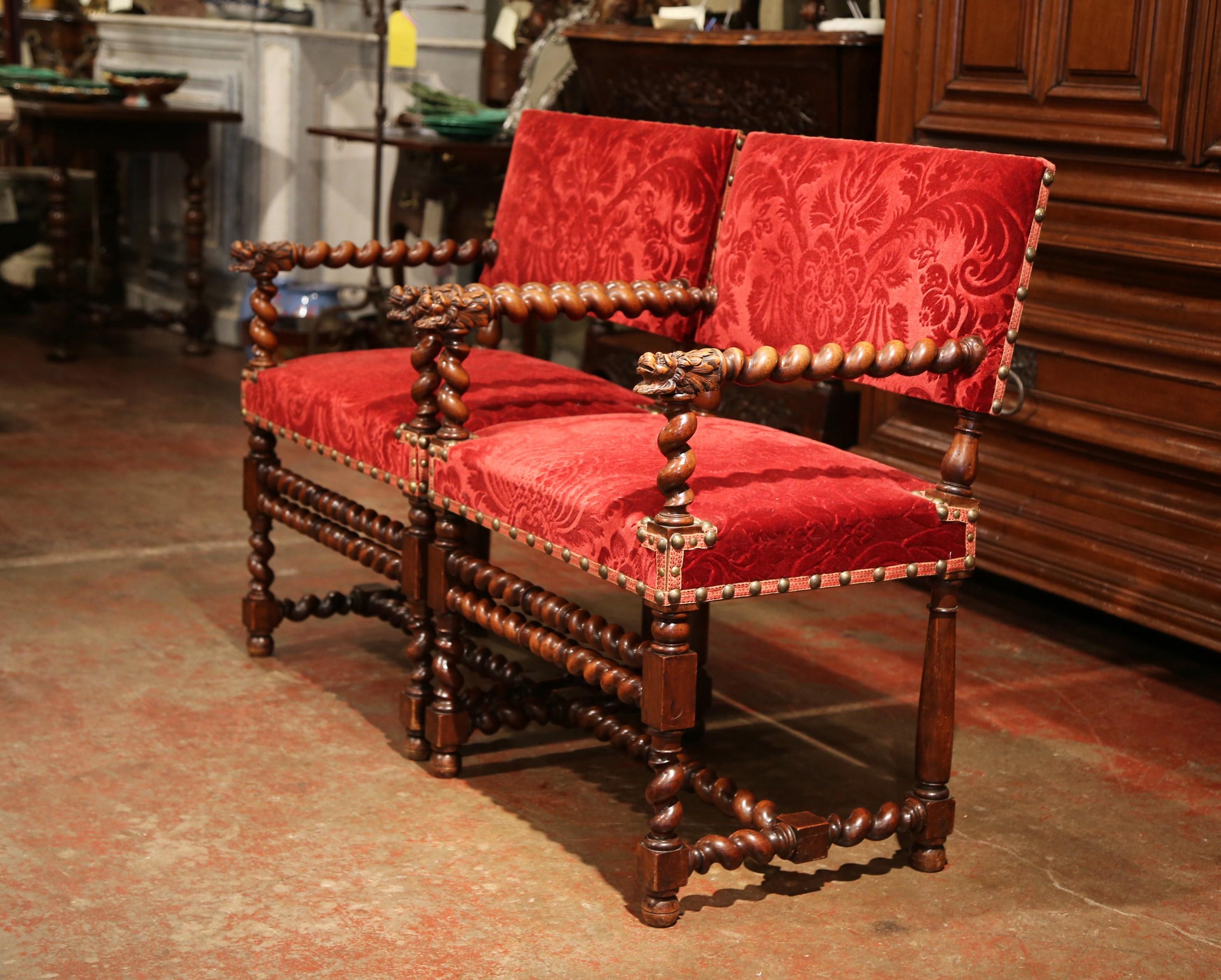 This elegant pair of antique fruit wood armchairs were created in the Perigord region of France, circa 1880. Each chair has a rectangular back, carved barley twist legs and a matching stretcher. Each armrest is embellished by hand-carved dog head