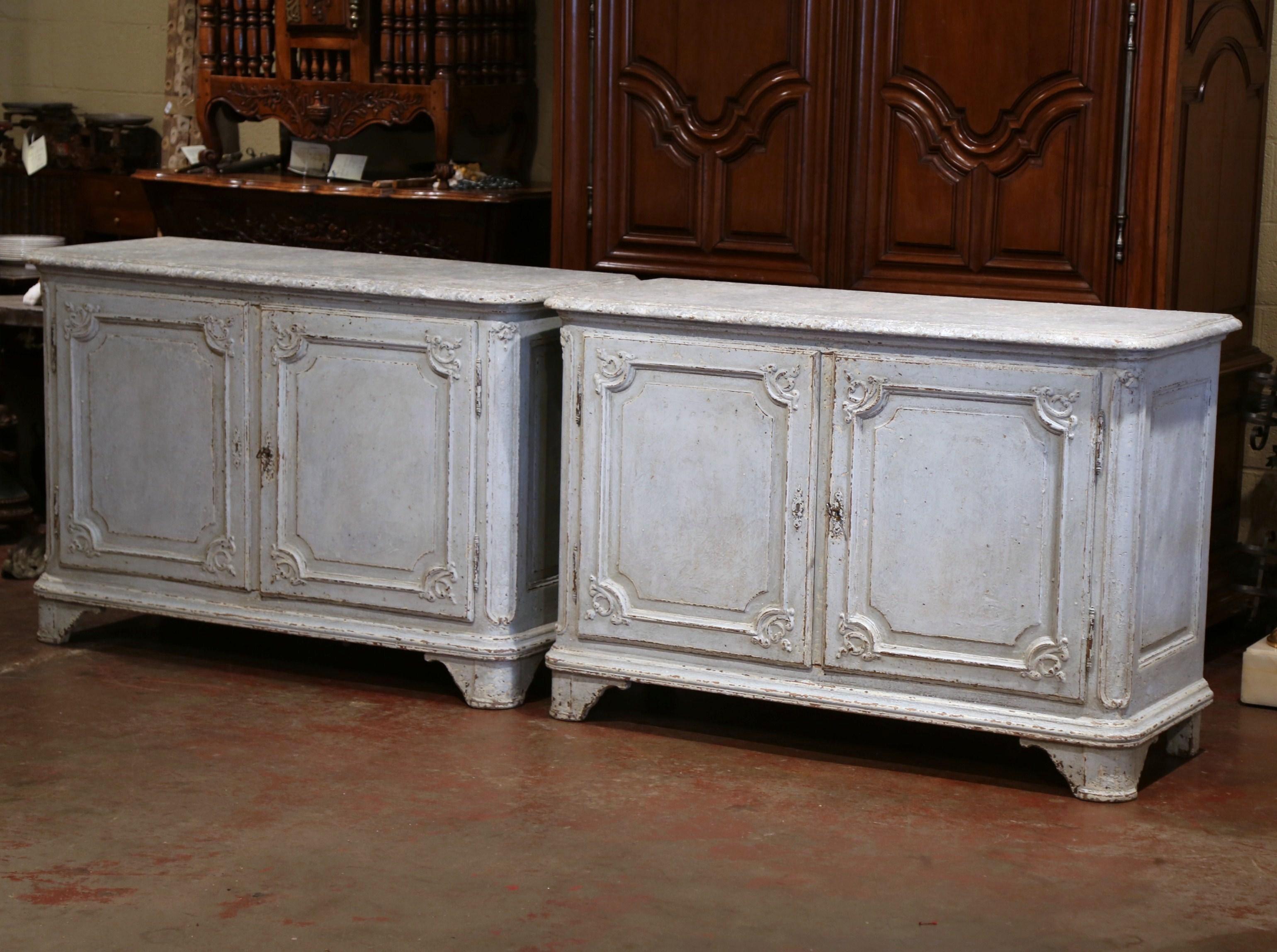 Crafted in Paris France, circa 1860, both cabinets with bowed front Stand on curved feet under a straight decorative plinth; each buffet with bombe facade, features two front doors with raised panels and carved floral motifs in all corners, and