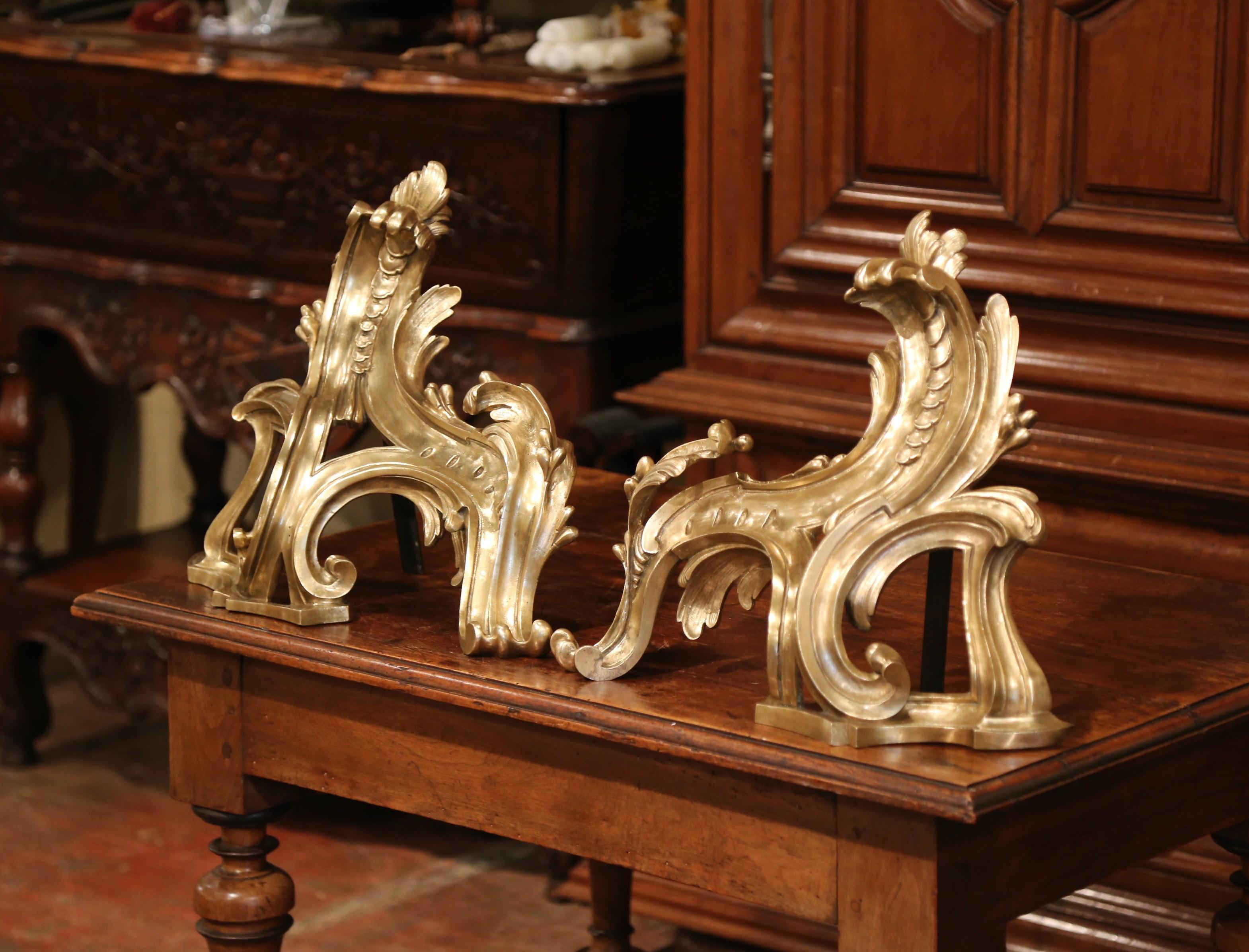 Decorate a fireplace with this large, elegant pair of gilt bronze chenets. Crafted in France circa 1860, each andiron features exquisite, ornate decorations with scroll and leaf motifs. The Baroque fireplace essentials are in excellent condition