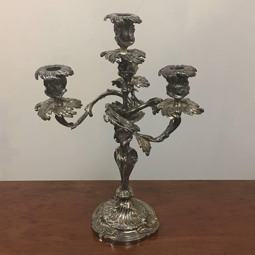This fine pair of French Louis XV bronze silvered bronze candelabra were cast entirely in silver plated bronze with Rococo style design in 19th century. They each crafted on a circular base with acanthus leaves and shell ornamentation, leading to an