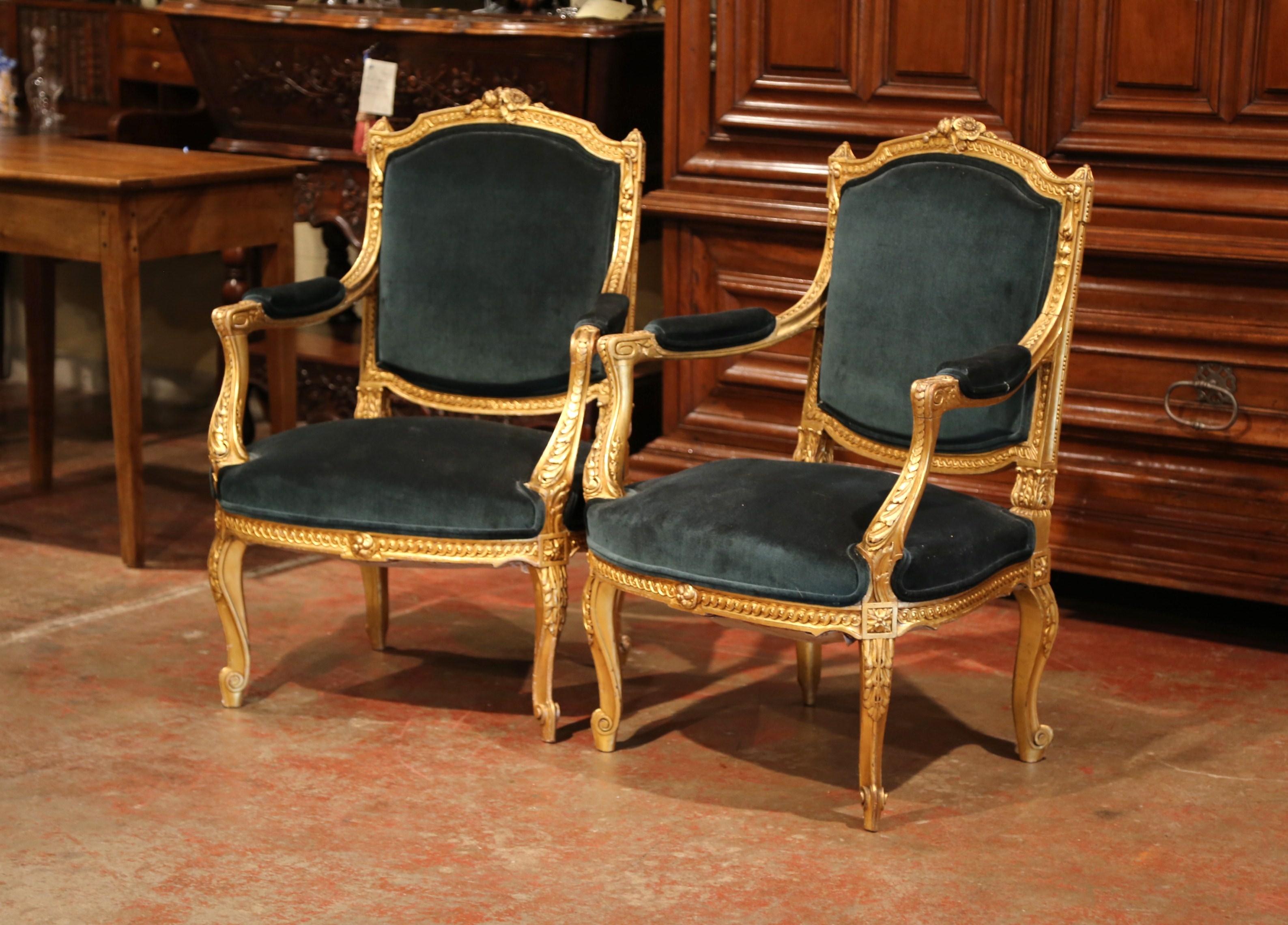 Place these elegant antique fauteuils in a living room or a study. Crafted in France circa 1870, each traditional, French armchair sits on cabriole legs decorated with carved acanthus leaves at the shoulder. The arched back is decorated with floral