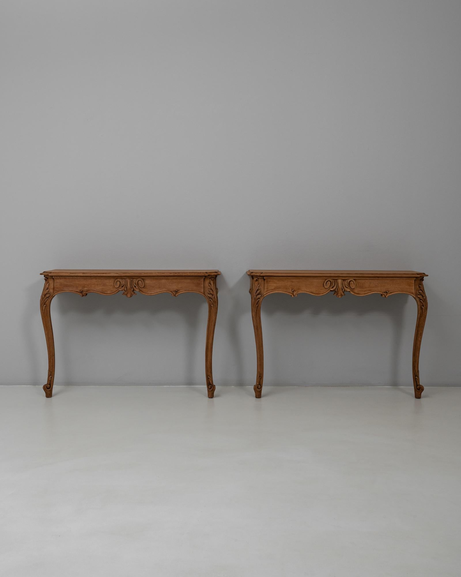 This pair of 19th Century French Louis XV oak console tables showcases the refined elegance and sculptural detailing characteristic of the period. Each table is crafted in solid oak with a warm, even patina that enhances the depth of the carved