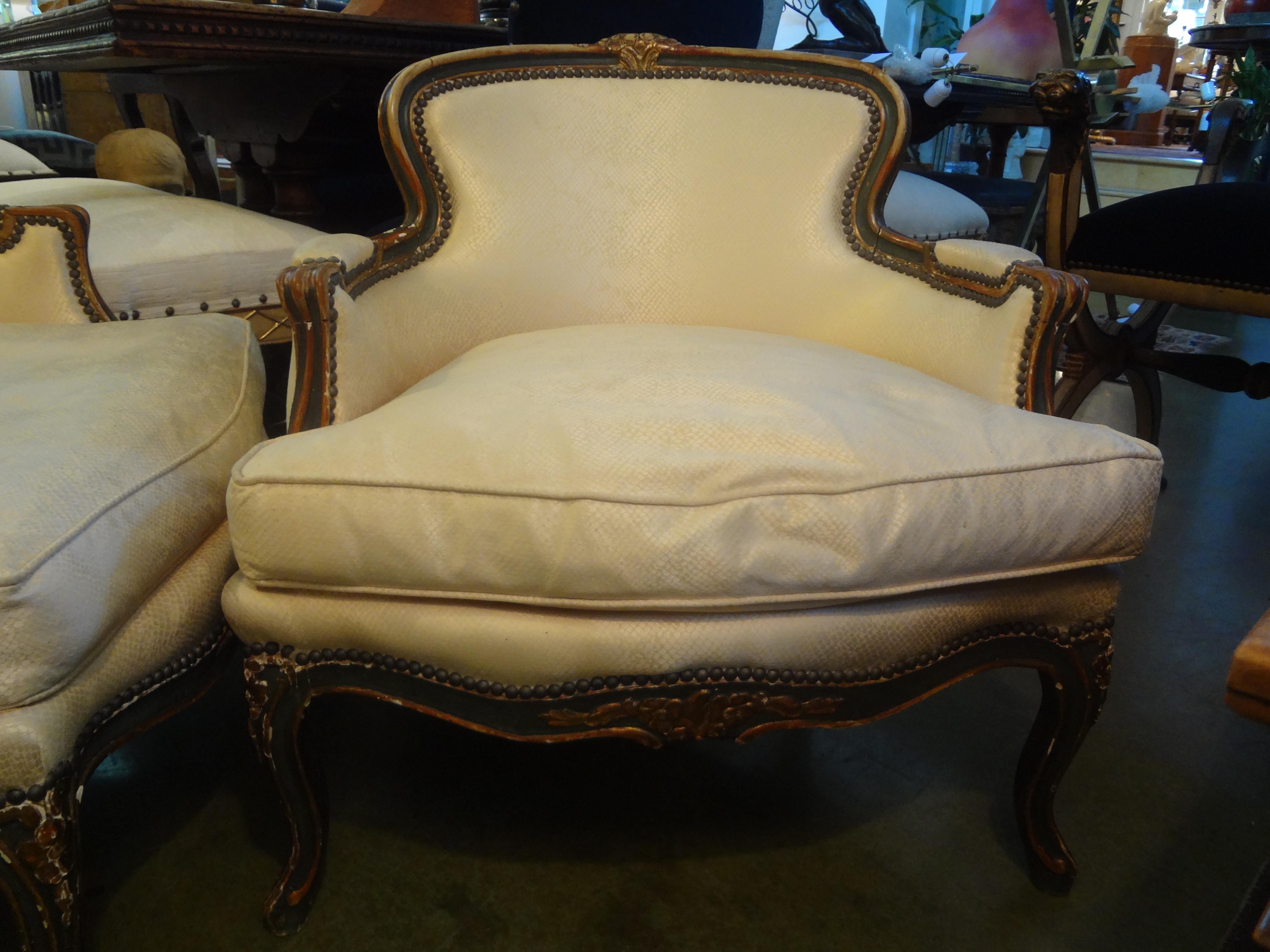 Stunning pair of 19th century French transitional Louis XV-Louis XVI style painted and giltwood bergères or chairs. Very comfortable and in great structural condition. Ready for your new upholstery. This is a versatile pair of lounge chairs dates to