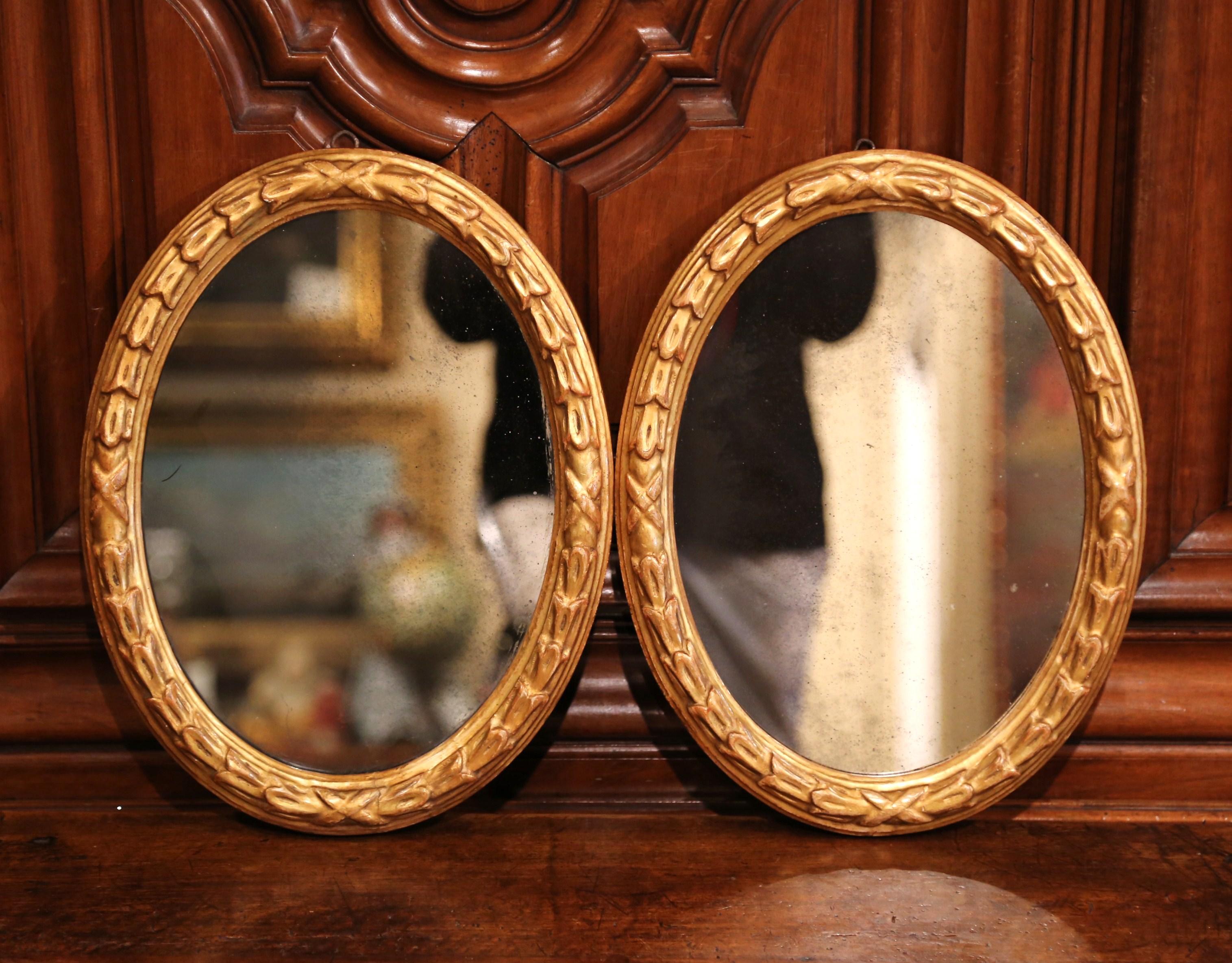 Pair of 19th Century French Louis XVI Carved Giltwood Oval Wall Mirrors In Excellent Condition In Dallas, TX