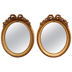 Pair of 19th Century French Louis XVI Carved Giltwood Oval Wall Mirrors