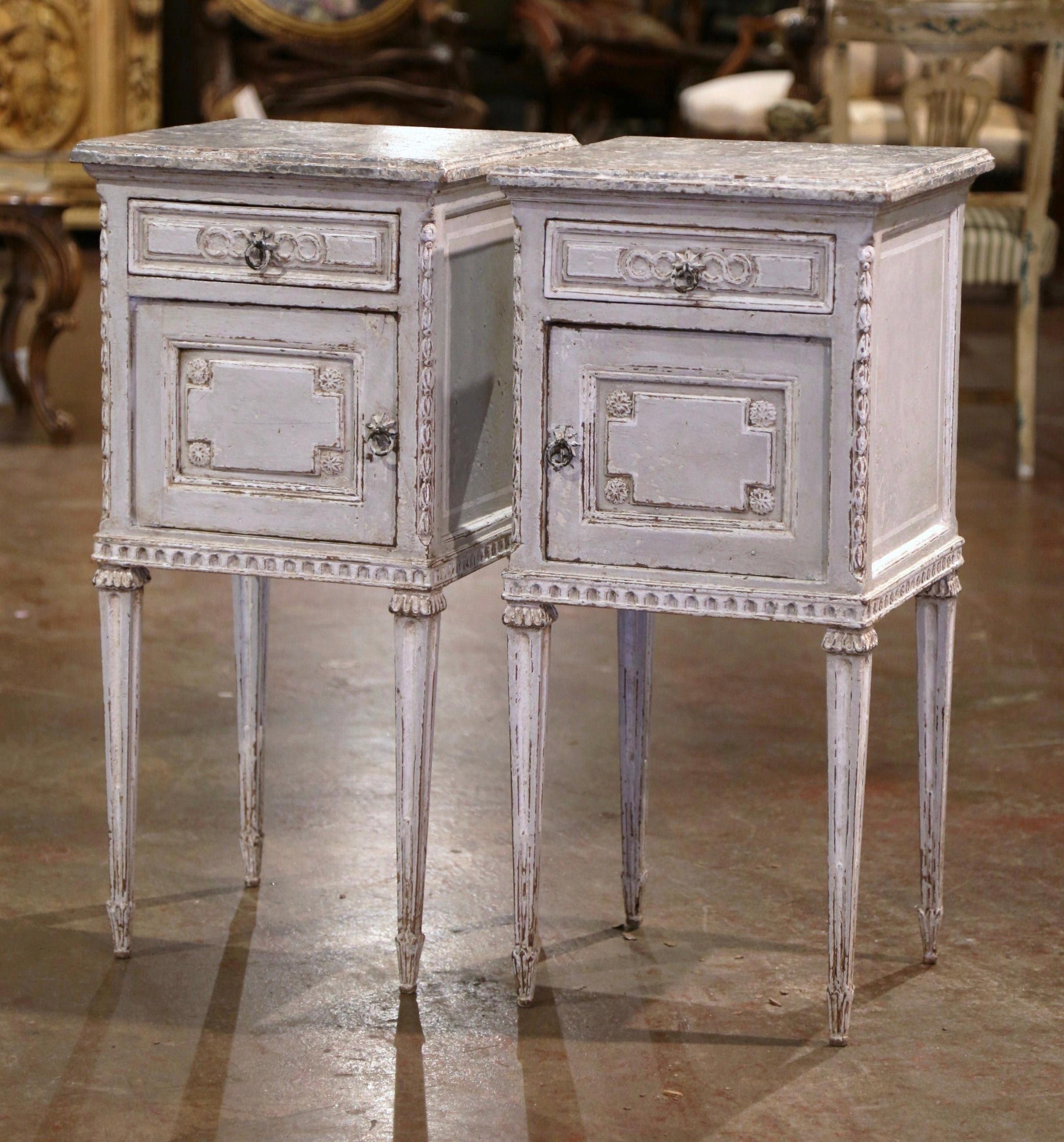 Complete your bedroom with this elegant pair of antique bedside cabinets; crafted in France, circa 1880, each matching cabinet with right and left door, stands on tapered fluted legs decorated with carved rings at the shoulders. The chest features a