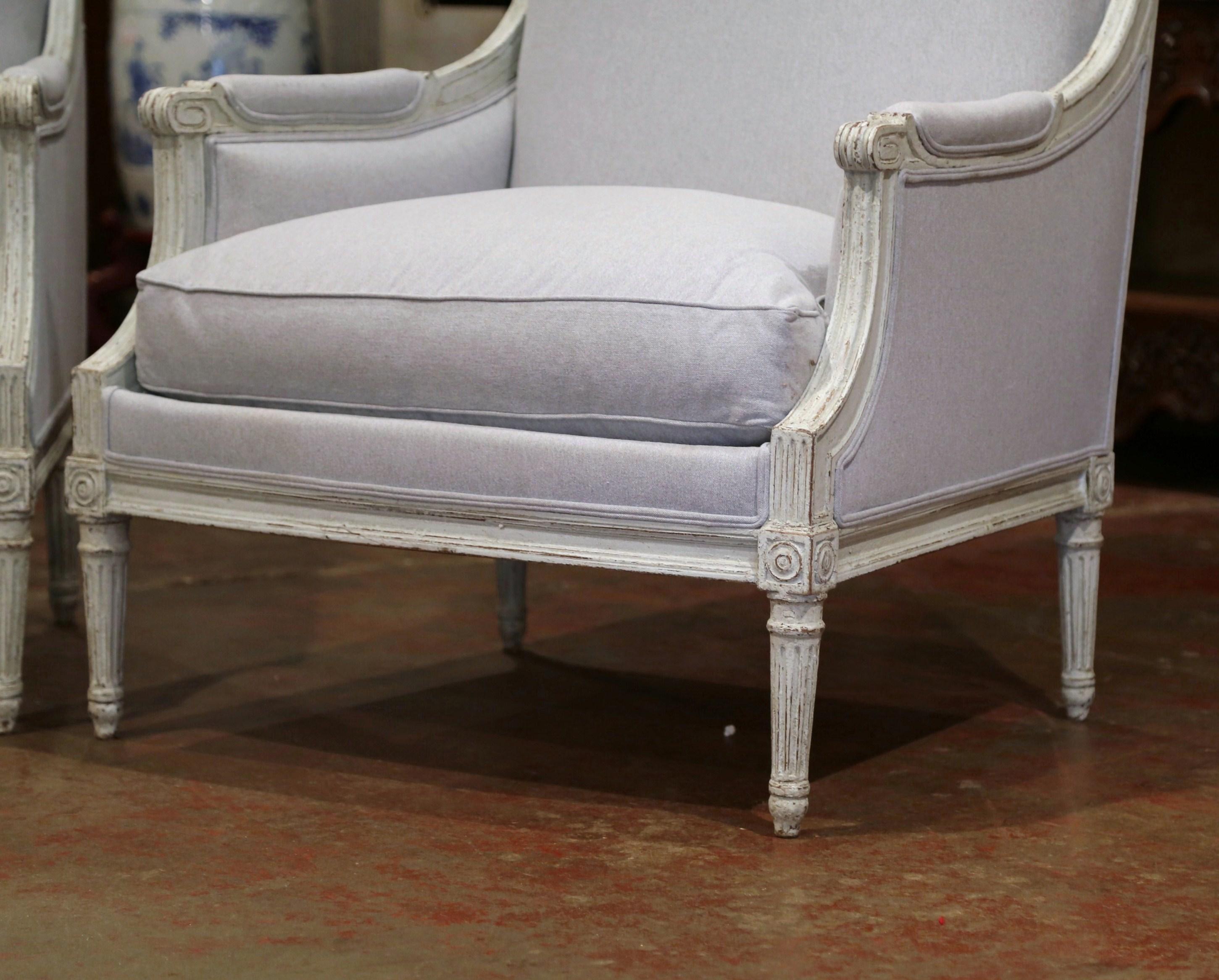 Complete your formal living room or den with this elegant pair of antique armchairs. Created in France, circa 1890, the large, Classic chairs have a wide and square back, and a deep and a comfortable seat. The traditional armchairs feature hand