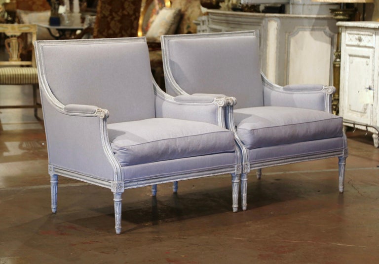 Complete your formal living room or den with this elegant pair of antique armchairs. Created in France, circa 1890, the large, Classic chairs have a wide and square back, and a deep and a comfortable seat. The traditional armchairs feature hand