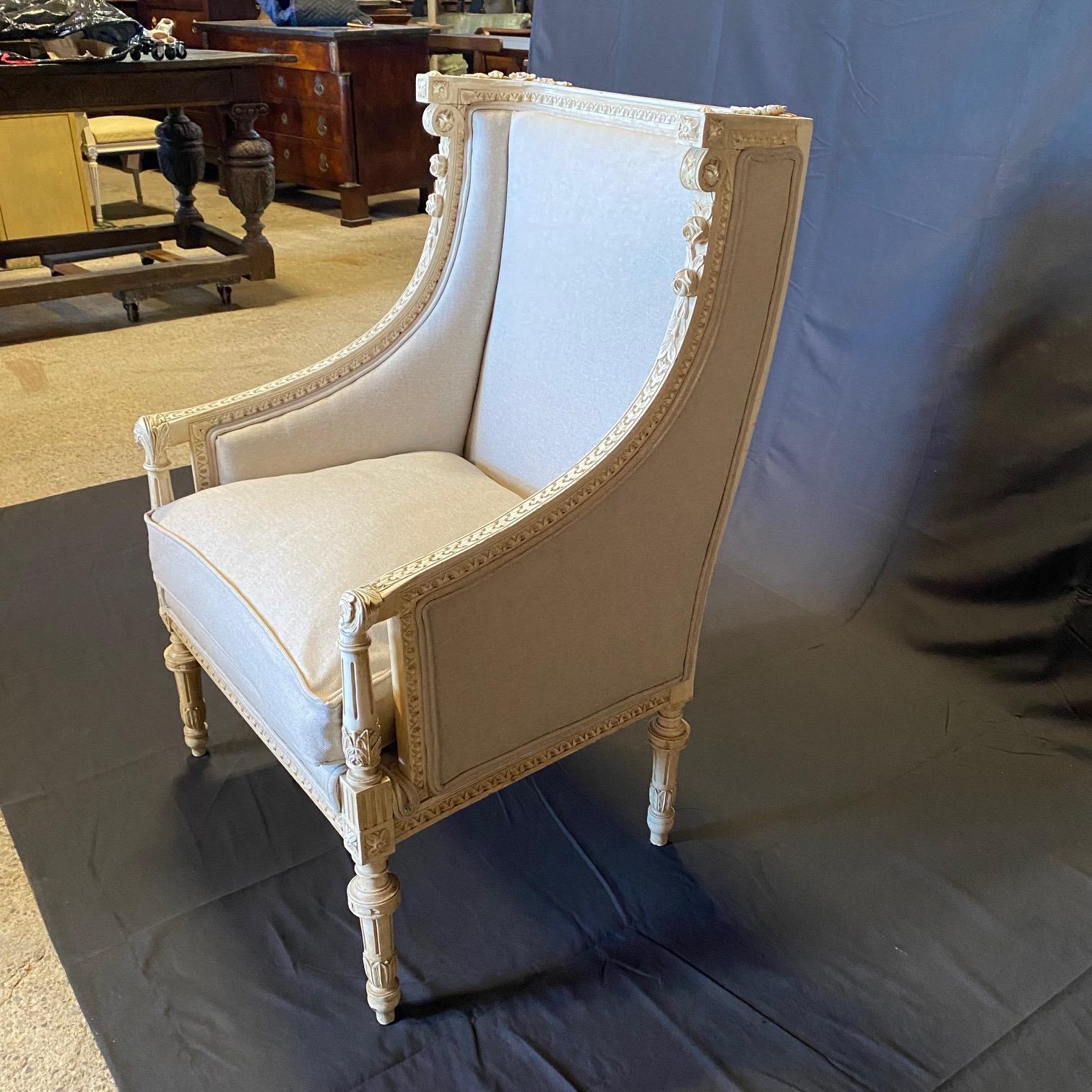 Complete your formal living room or den with this elegant pair of antique wingchairs or armchairs. Created in France, circa 1880, the large, classic bergeres stand on carved tapered and fluted legs. Each wide back features very finely carved details