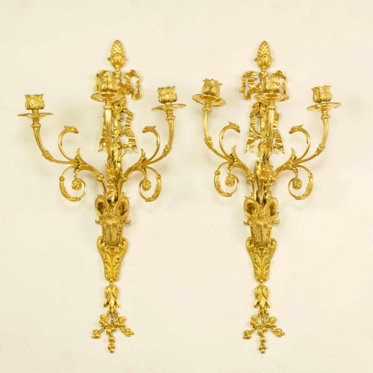Pair of large French 19th century Louis XVI goat heads three-light wall lights/sconces

A pair Louis XVI style gilt bronze three-branch wall lights, each with a backplate the lower part of which is in the form of a goat's head resting on a foliage