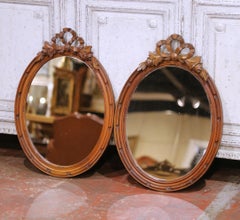 Pair of 19th Century French Louis XVI Oval Walnut Mirrors with Ribbon Crest