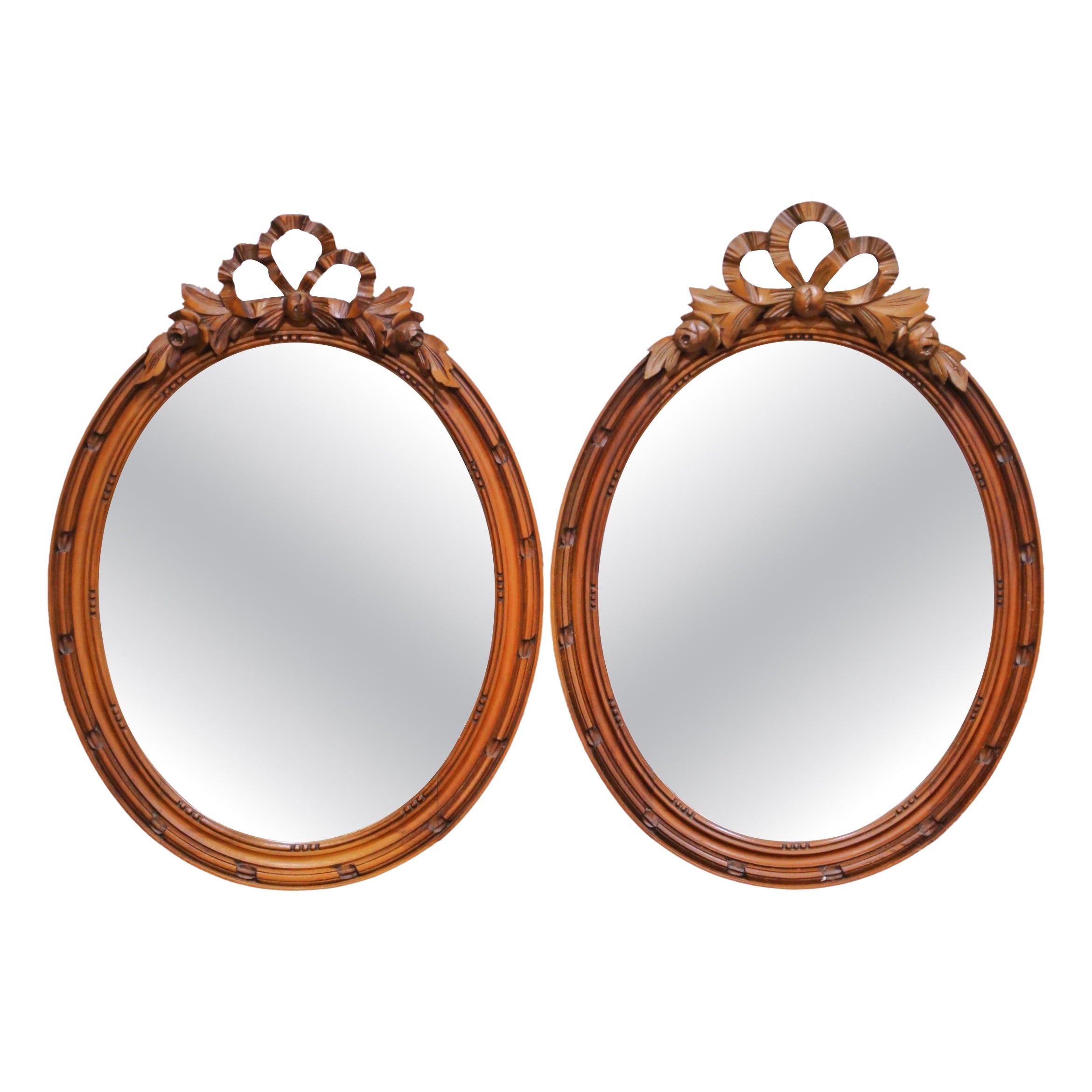 Pair of 19th Century French Louis XVI Oval Walnut Mirrors with Ribbon Crest