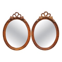 Pair of 19th Century French Louis XVI Oval Walnut Mirrors with Ribbon Crest