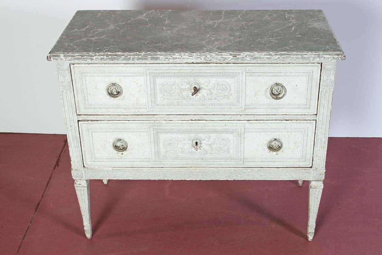 Place these antique two-drawer commodes as bedside tables in a master bedroom, or in a living room on either side of a mantel; crafted in northern France, circa 1880, each painted chest sits on four carved tapered and fluted legs, and features two