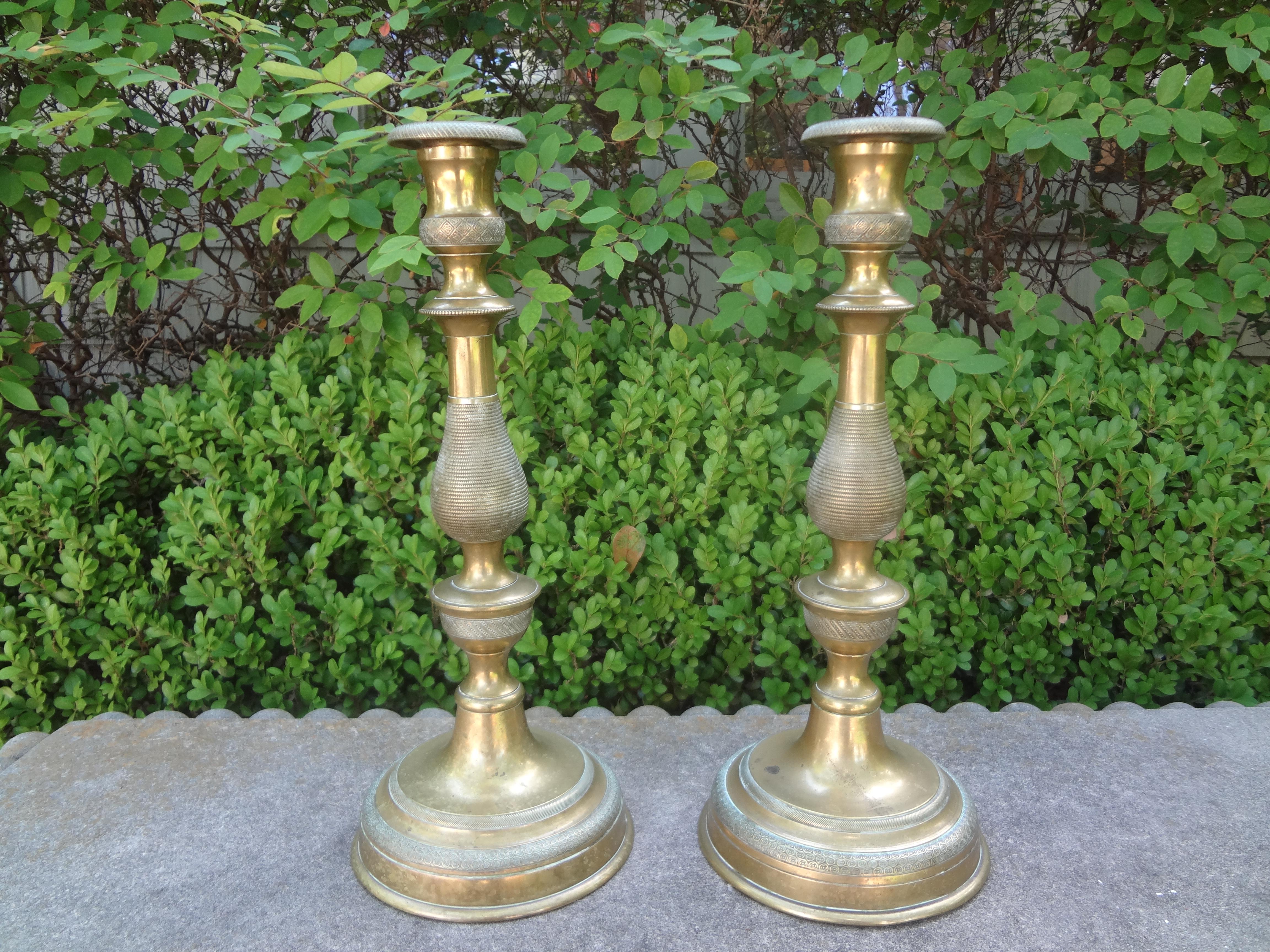 Pair of 19th century French Louis XVI style bronze candlesticks. This beautiful pair of French Napoleon III bronze candlesticks or candleholders have a beautiful etched design and will make a lovely addition to your dining table or coffee table.