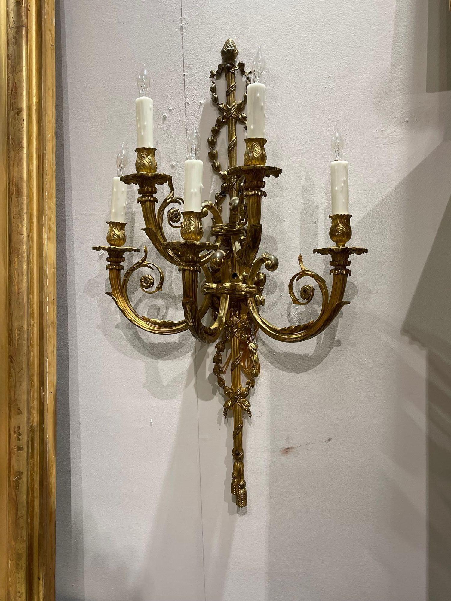 Exquisite pair of 19th century French Louis XVI style gilt bronze wall sconces with 5 lights. Beautiful designs including floral designs, decorative rope and a acorn finial at the top. A true classic that is sure to impress!!