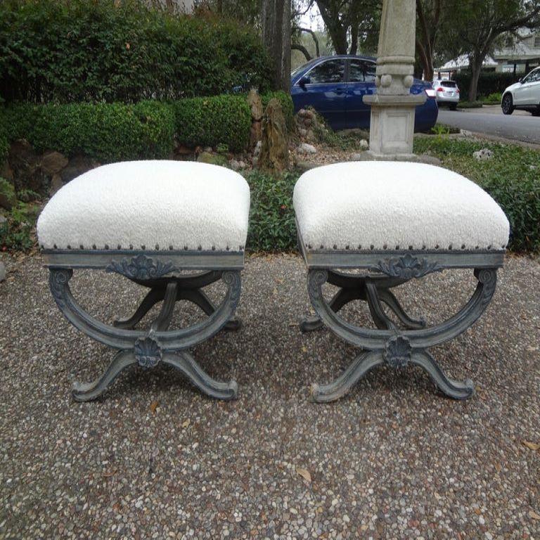 Stunning pair of 19th century French Louis XVI style painted X-shaped benches or ottomans. This fabulous comfortable pair of antique French benches or ottomans are painted a beautiful gray-blue and professionally upholstered in white luxe plush